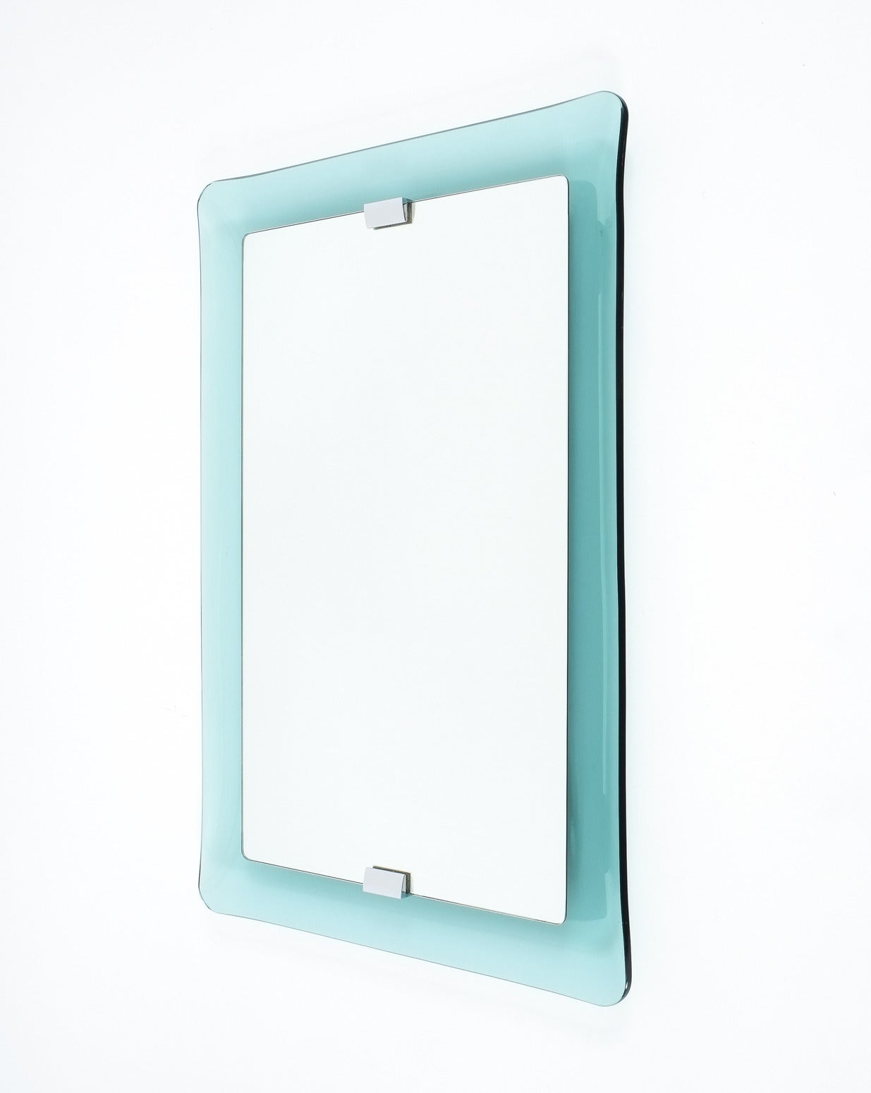 Large curved glass floating mirror by crystal Arte Glass circa 1950.

Beautiful crystal Arte mirror (Manufacturer, Italy) featuring a rectangular mirror floating over a delicately curved blue-greenish or turquoise thick glass frame that is also