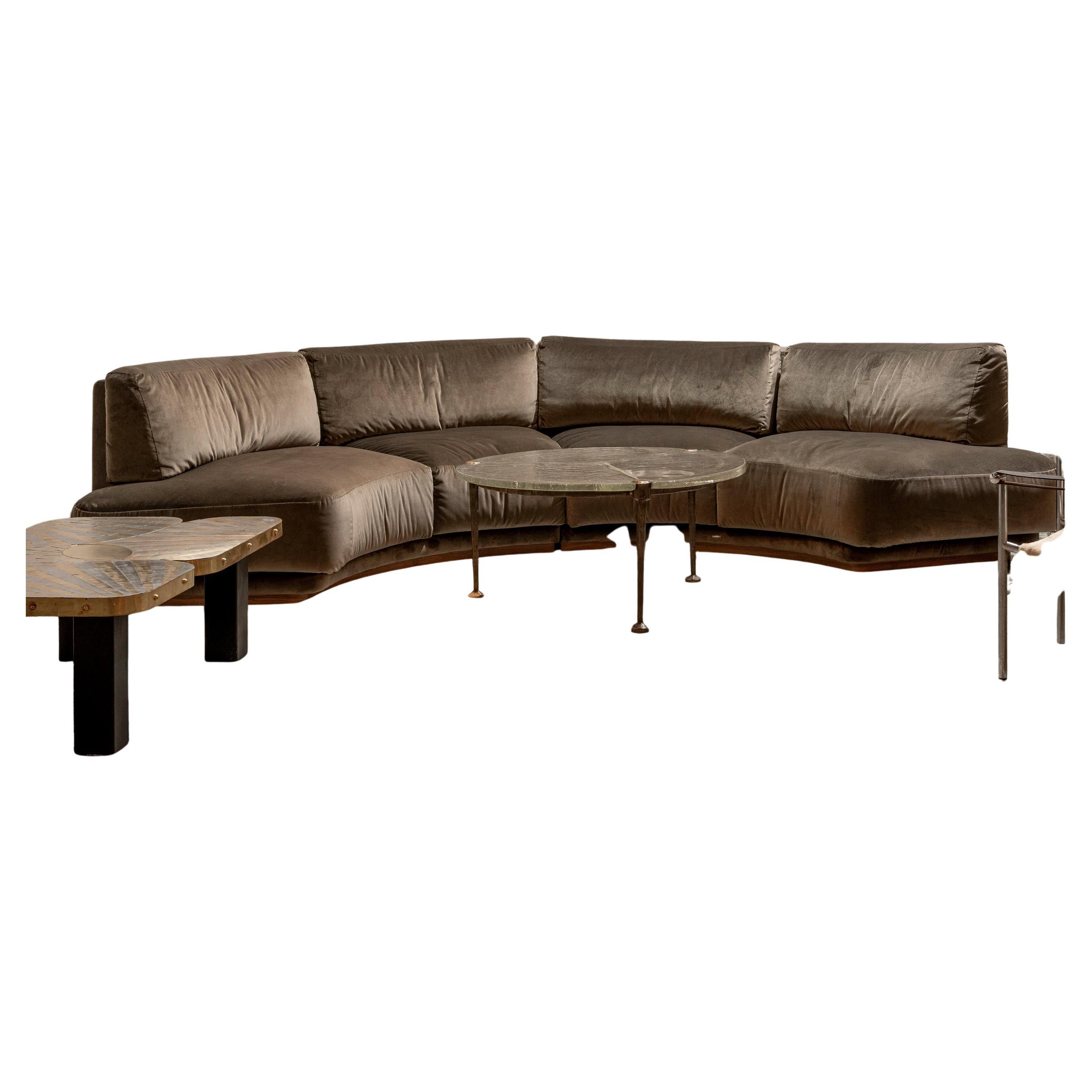 Large curved sofa in velvet