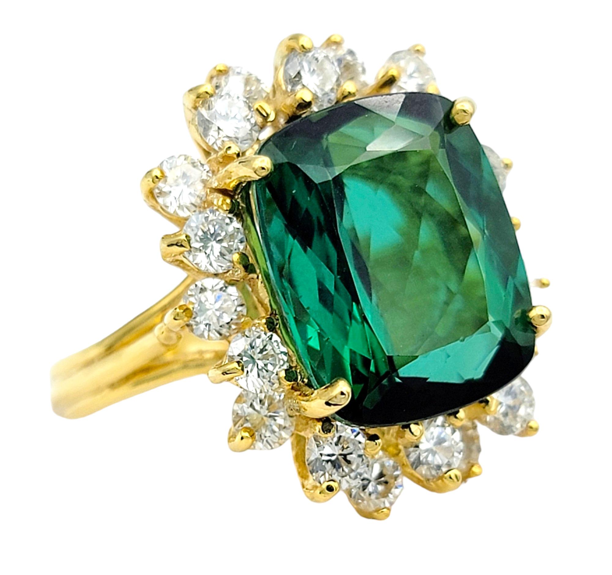 Ring Size: 6.5

This stunning ring showcases a vibrant cushion-cut green tourmaline as its centerpiece, radiating with natural beauty and allure. Surrounding the tourmaline is a dazzling halo of sparkling diamonds, enhancing its brilliance and