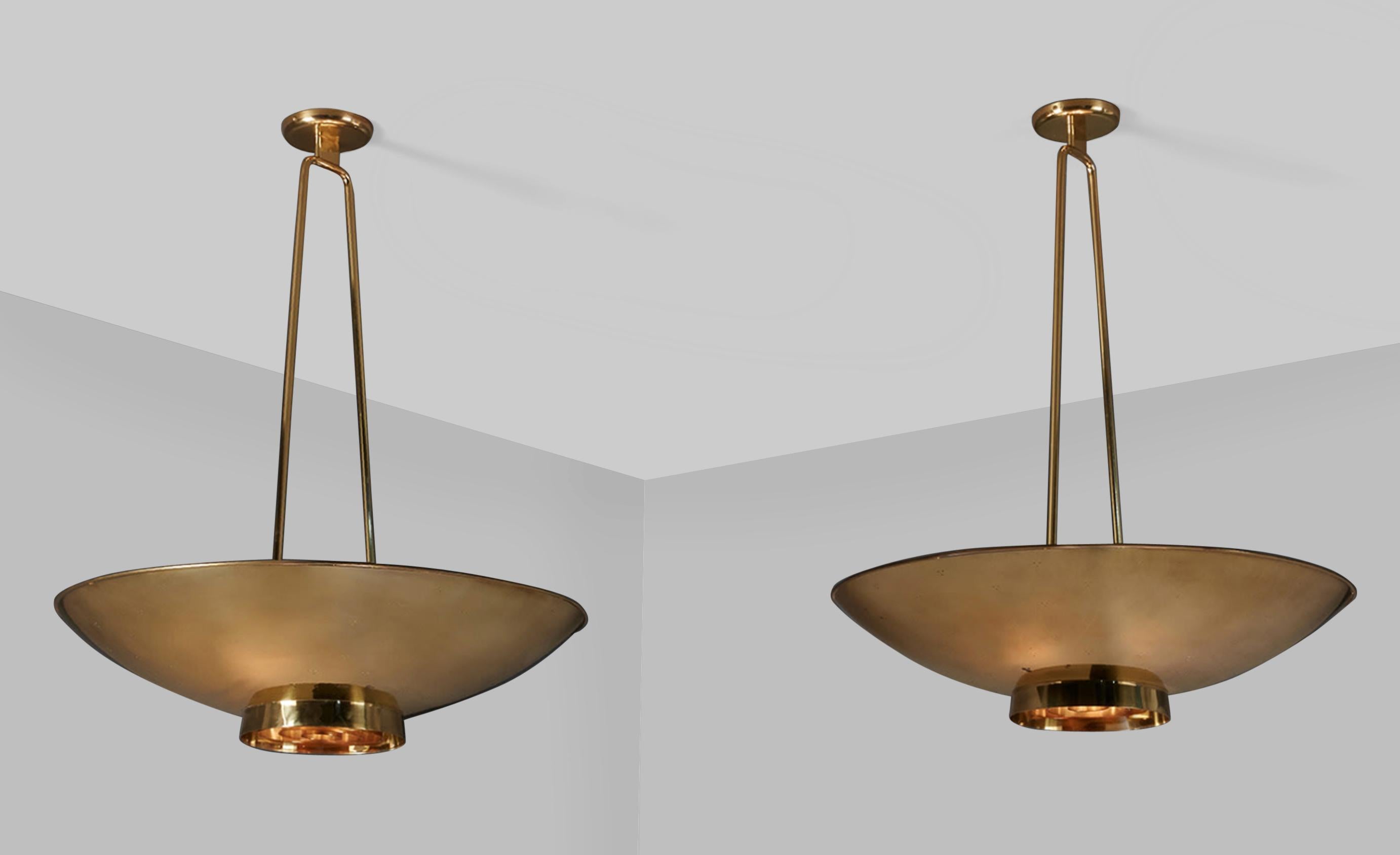 Paavo Tynell

Pair of custom large ceiling lights

brass
Each: 42 in. height, 30 in. diameter
Taito Oy, Helsinki, Finland.

A large pair of custom Paavo Tynell ceiling lights in solid brass. The lights feature a three-hole perforation