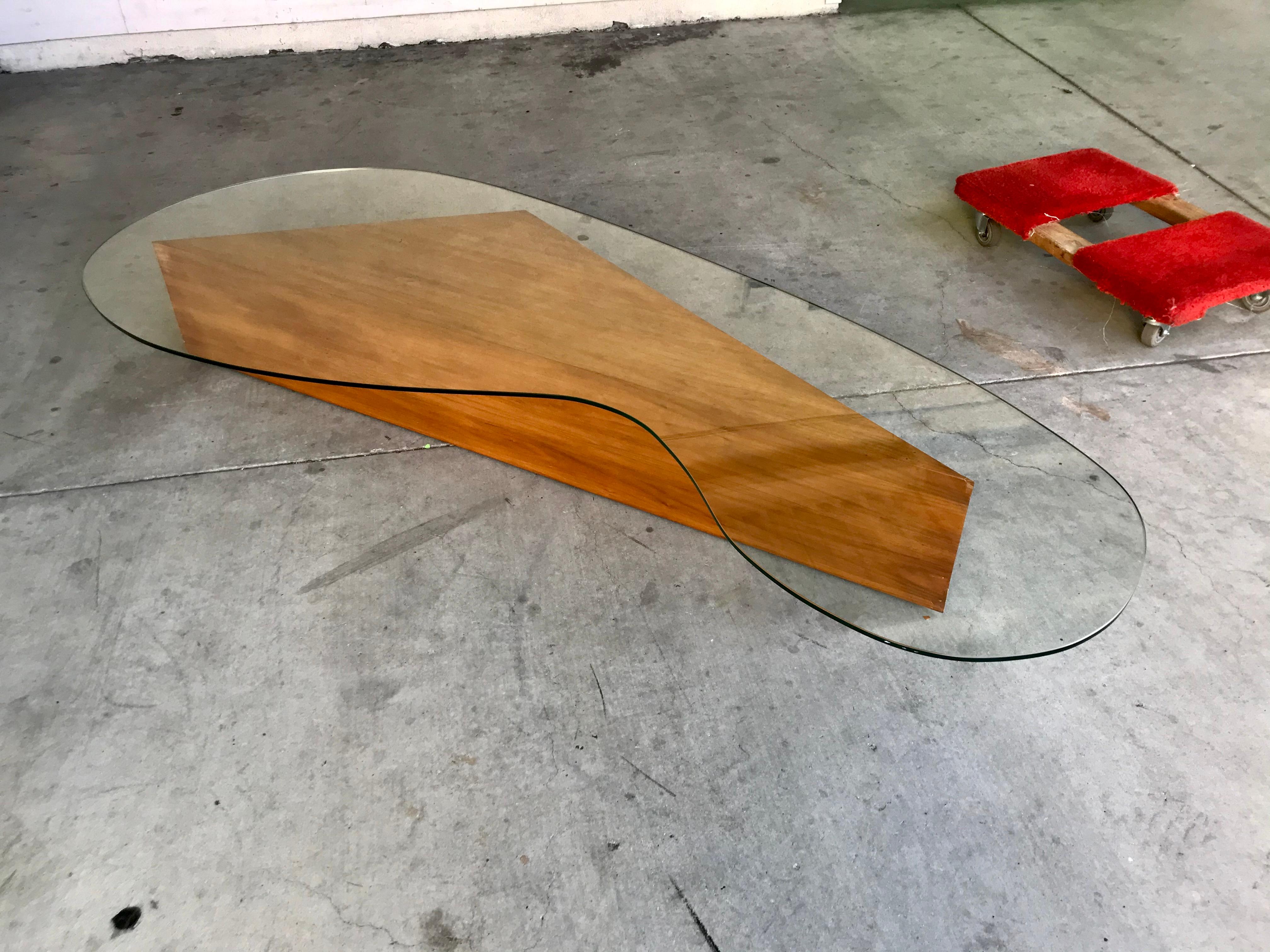 This table came from an Edward Fickett designed house in Bel Air California.
Fickett was known to incorporate some of his own one-off furniture designs into the homes he built.
Simple plywood modernist / informal design with a trapezoid obtuse base