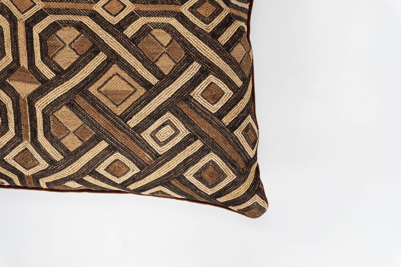 Large custom cushion from vintage African Kuba cloth. Hand-dyed raphia palm handwoven in an intricate pattern. Backed by brown velvet. Includes zip fastener and feather insert.