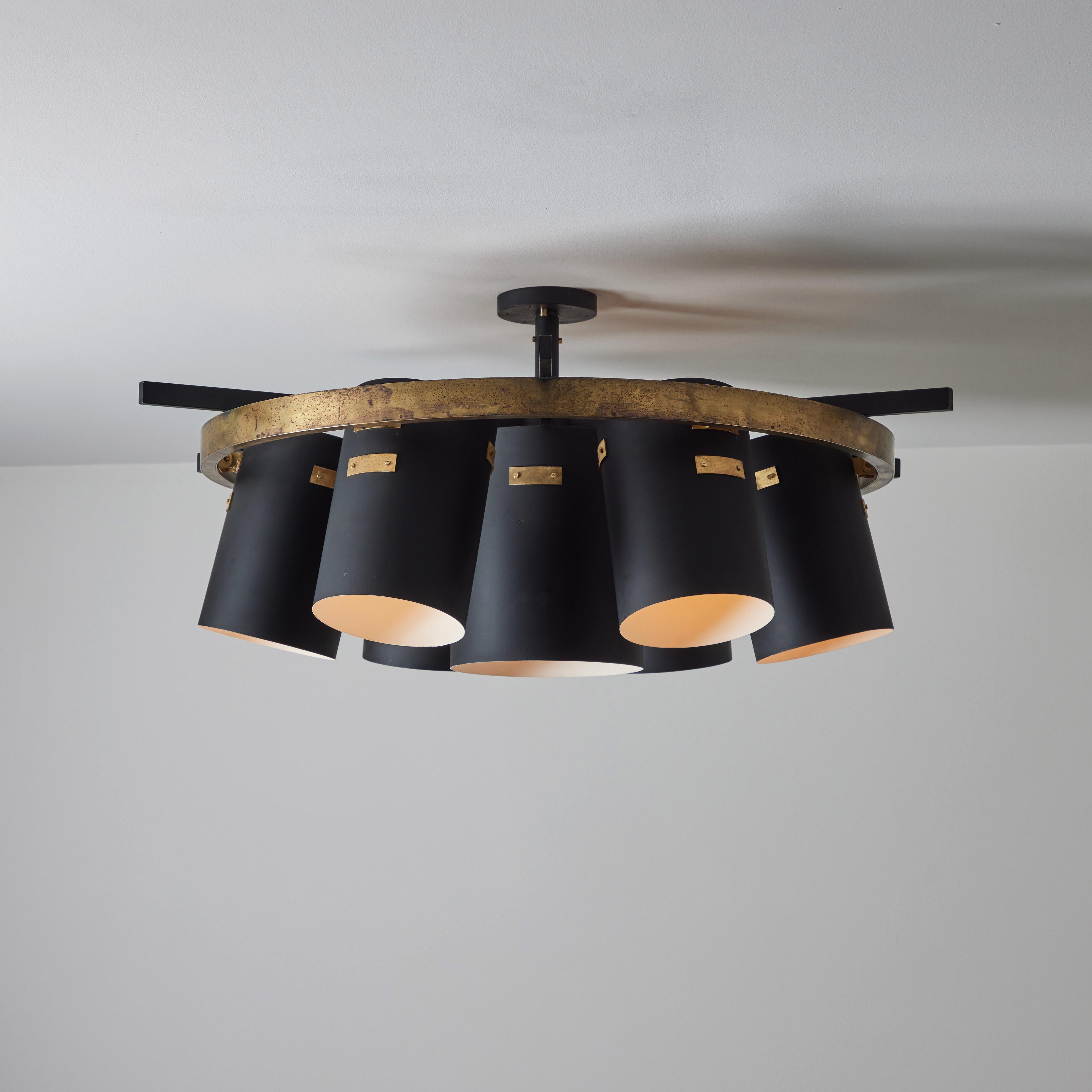 Single large custom Italian ceiling light. Designed and manufactured in Italy, circa the 1960s. Black enameled drums are situated around a large brass wheel. All drums can articulate between ten and twenty degrees outwards. Wired for the US. Holds