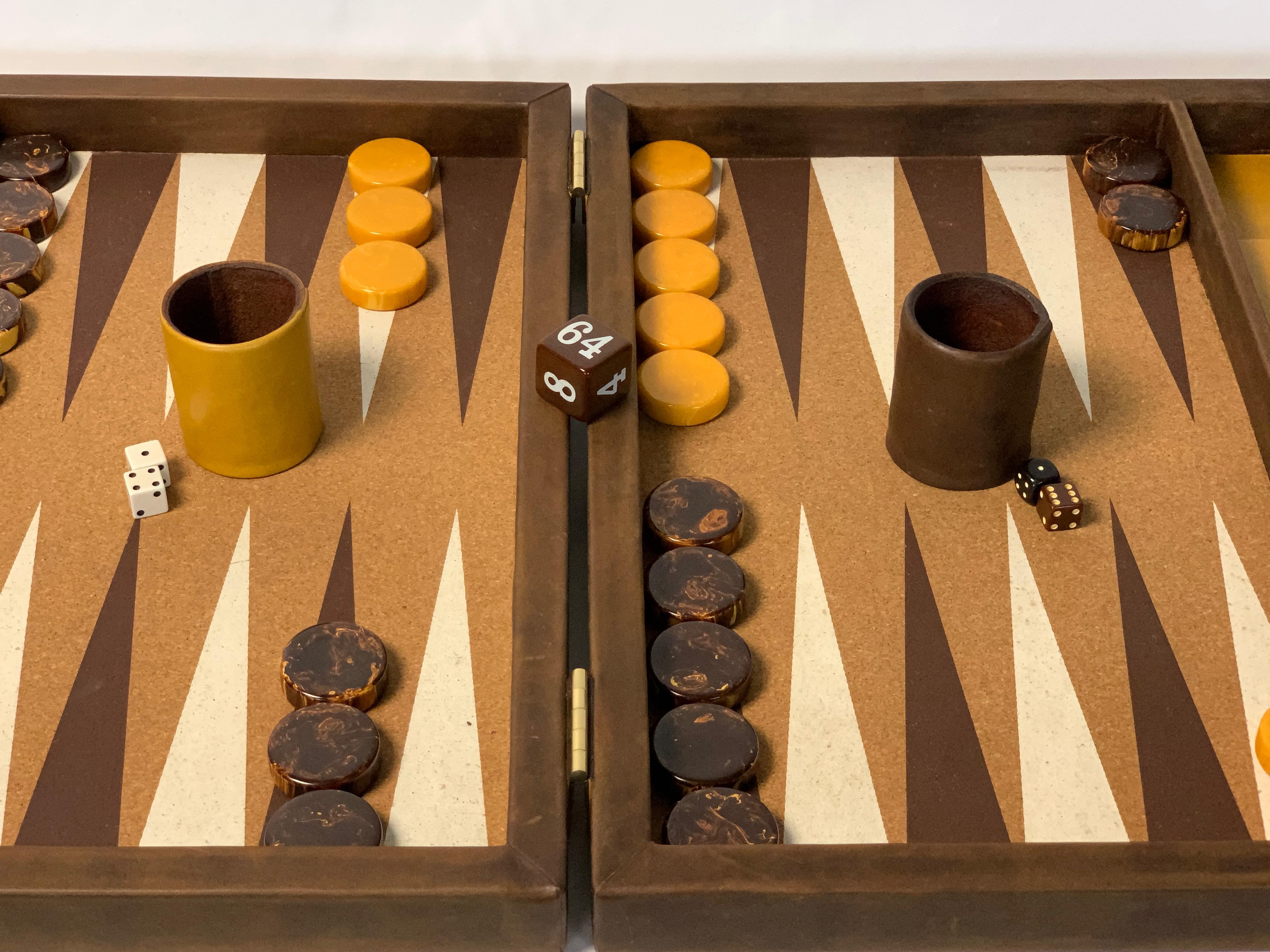 A large and impressive bespoke backgammon set done in chocolate brown and mustard yellow leather with cork playing surface and large bakelite playing pieces.