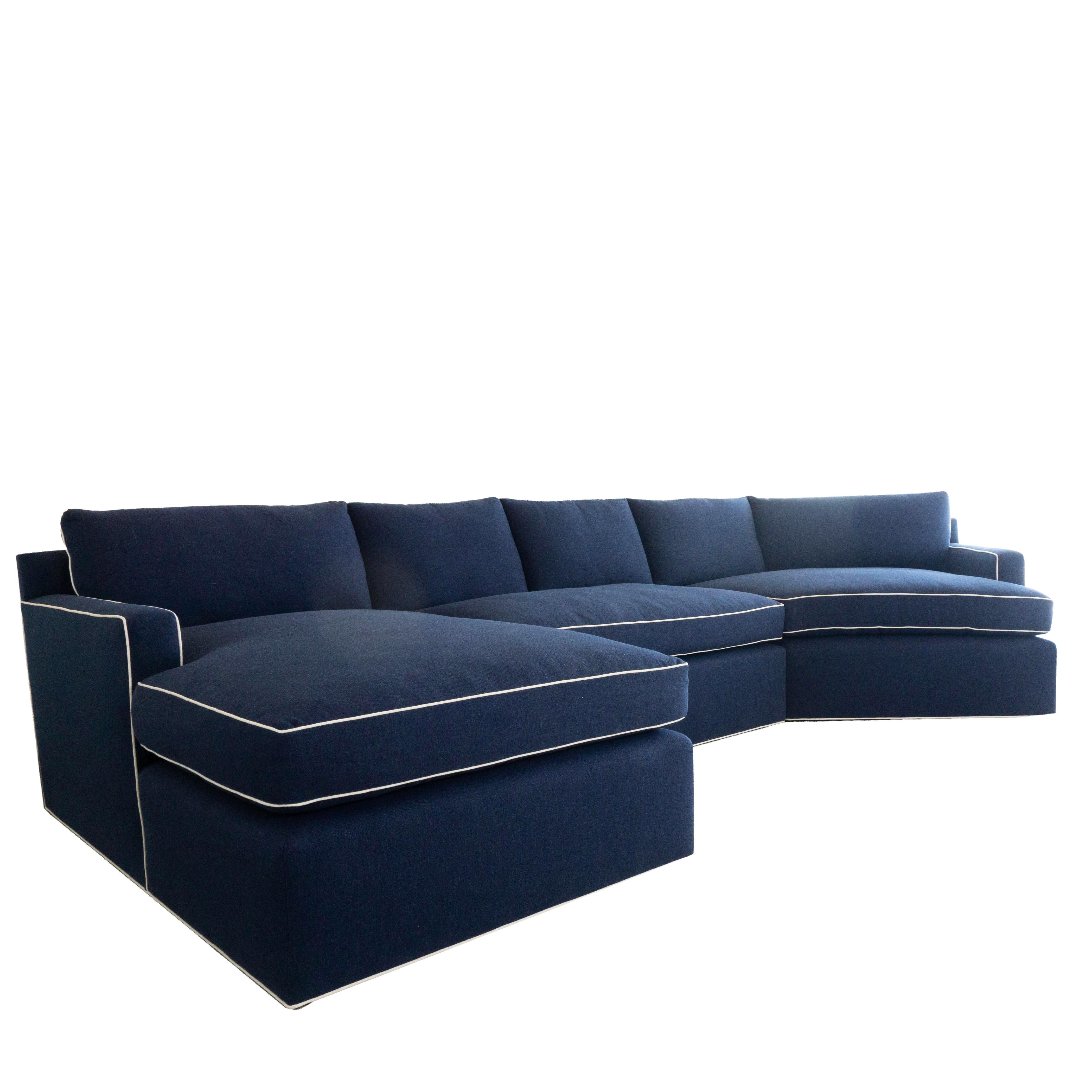 This sectional sofa was a custom order that features three sections: a chaise lounge, loveseat and pod chaise. It also features a low back, with track arms. The back cushions are stuffed with high density foam and feather wrapped in dacron. The sofa