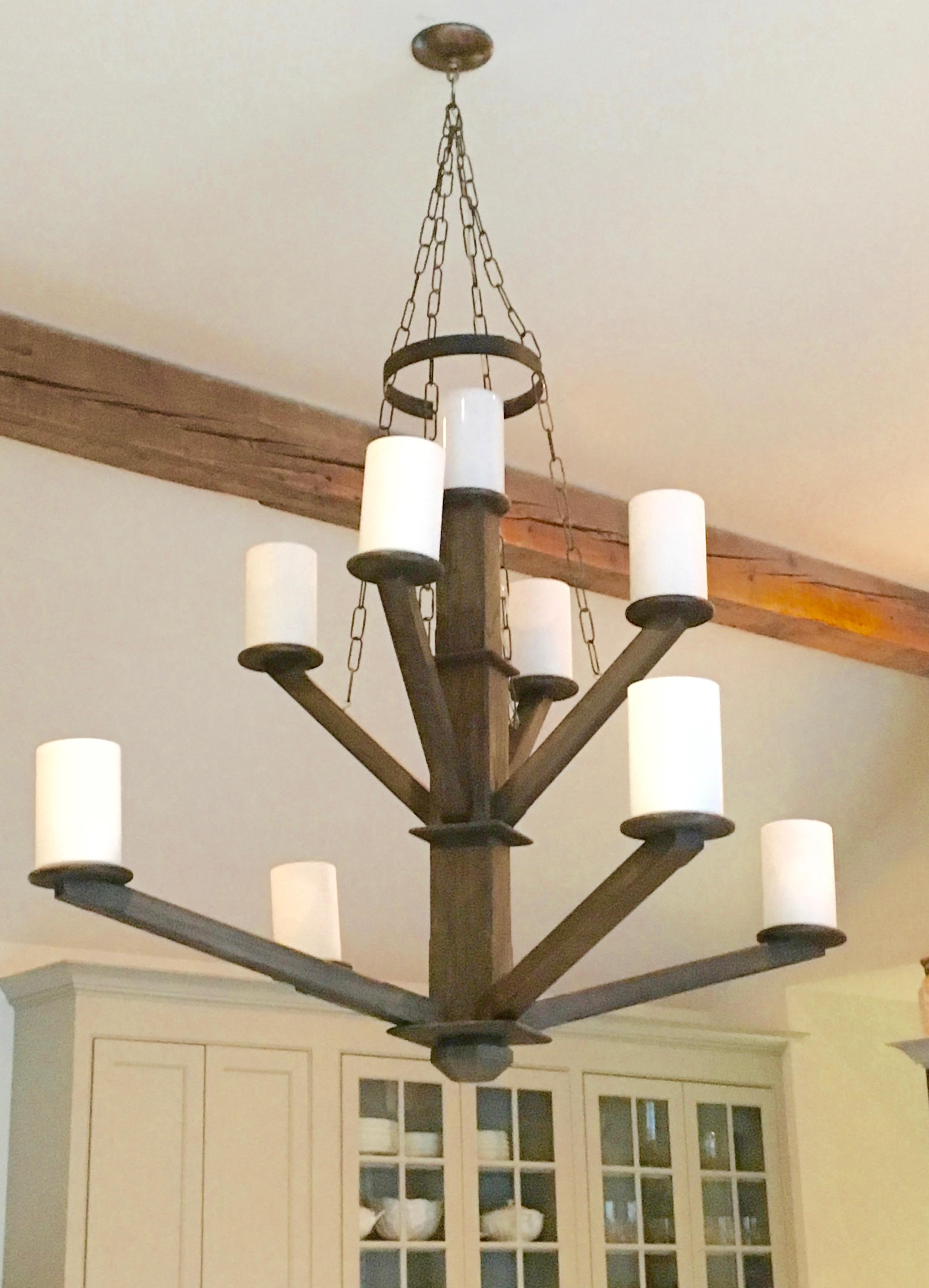 Large Avantgarden custom-made black walnut wood chandelier, with iron details and shown with milk glass cylinder shades. 
Custom woods and stain options are available.

Avantgarden has been cultivating great lighting, furniture and design in Pound