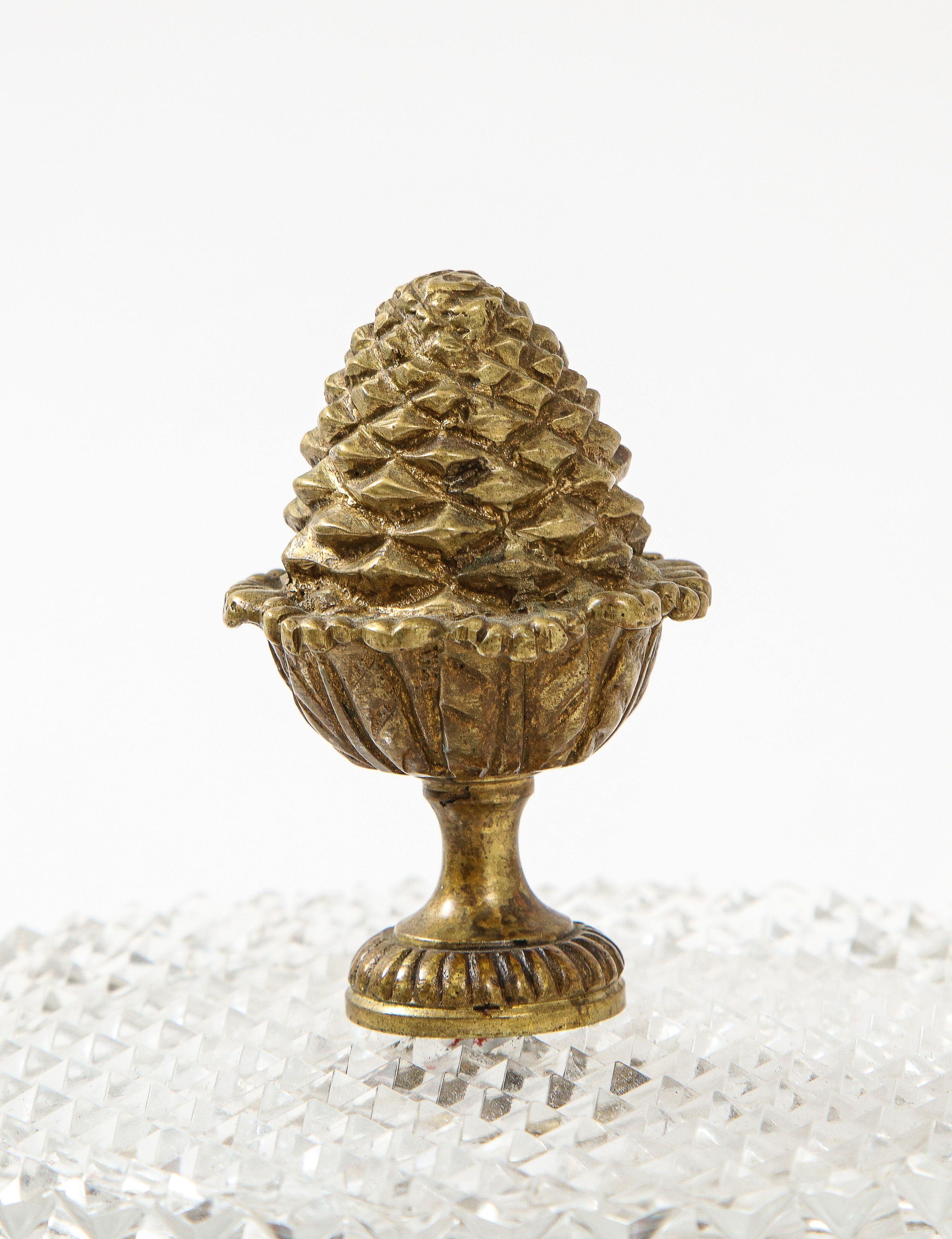 A great large cut crystal hinged lidded box with brass acorn finial.