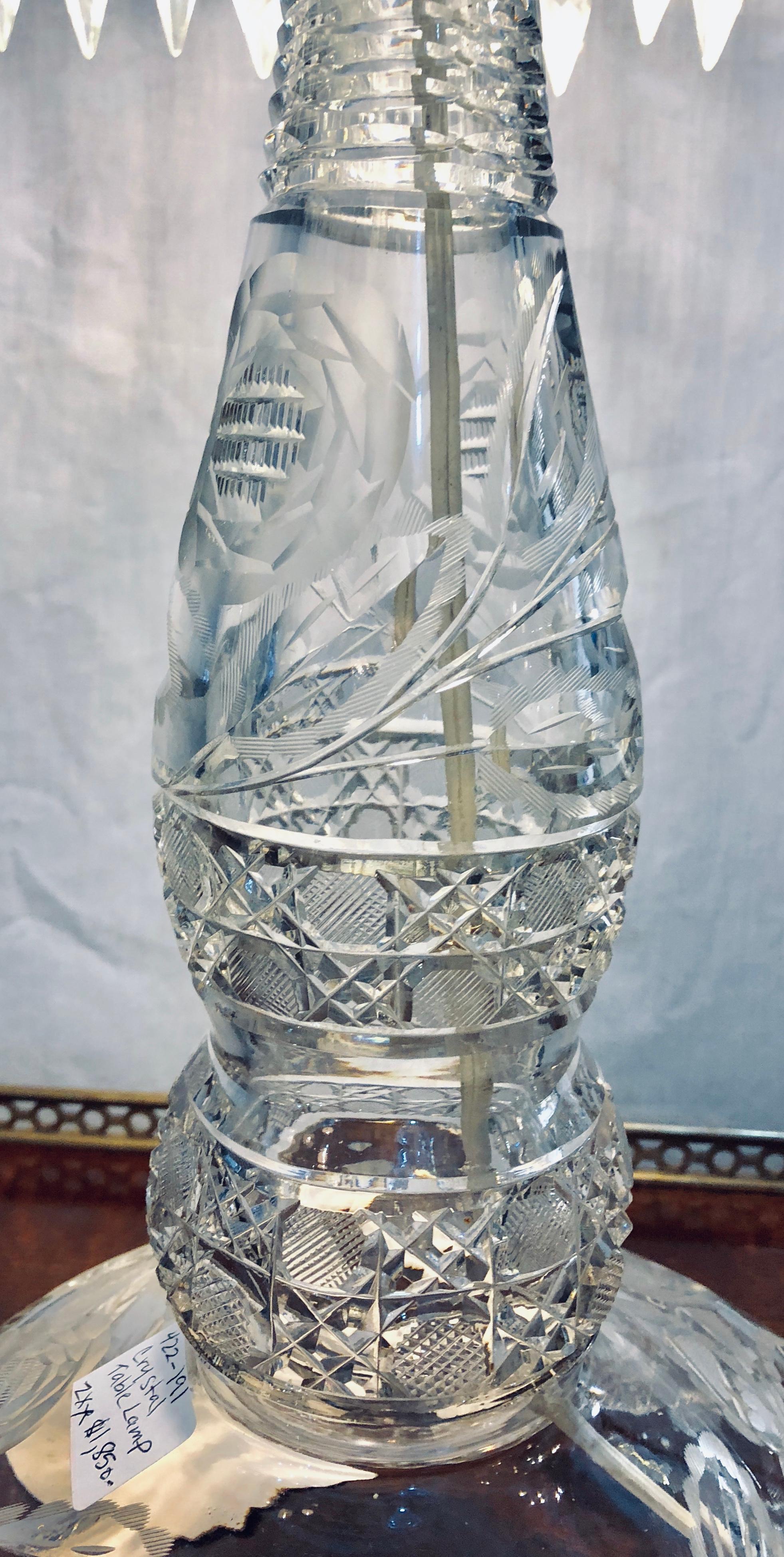 Large cut glass and crystal domed shaded table lamp. This finely cut glass table lamp is seemingly stunning with its matching shade and hanging prisms.