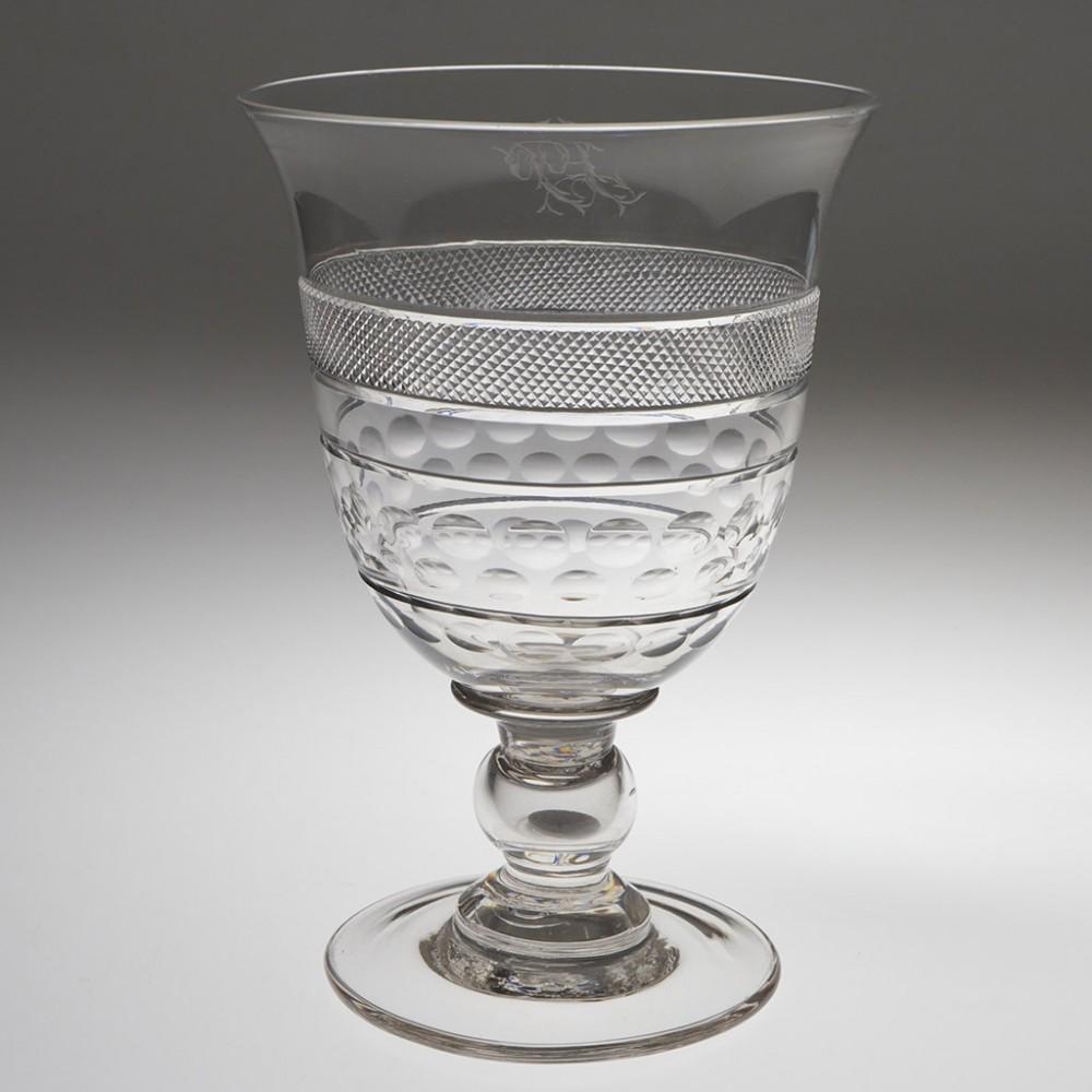 Heading : Large cut glass coin goblet
Period : Victoria - c1840
Origin : England
Colour : Clear
Bowl : Round funnel with everted rim, band of finely cut strawberry diamonds, two band of lens cutting set between parallel cut bands and a band or