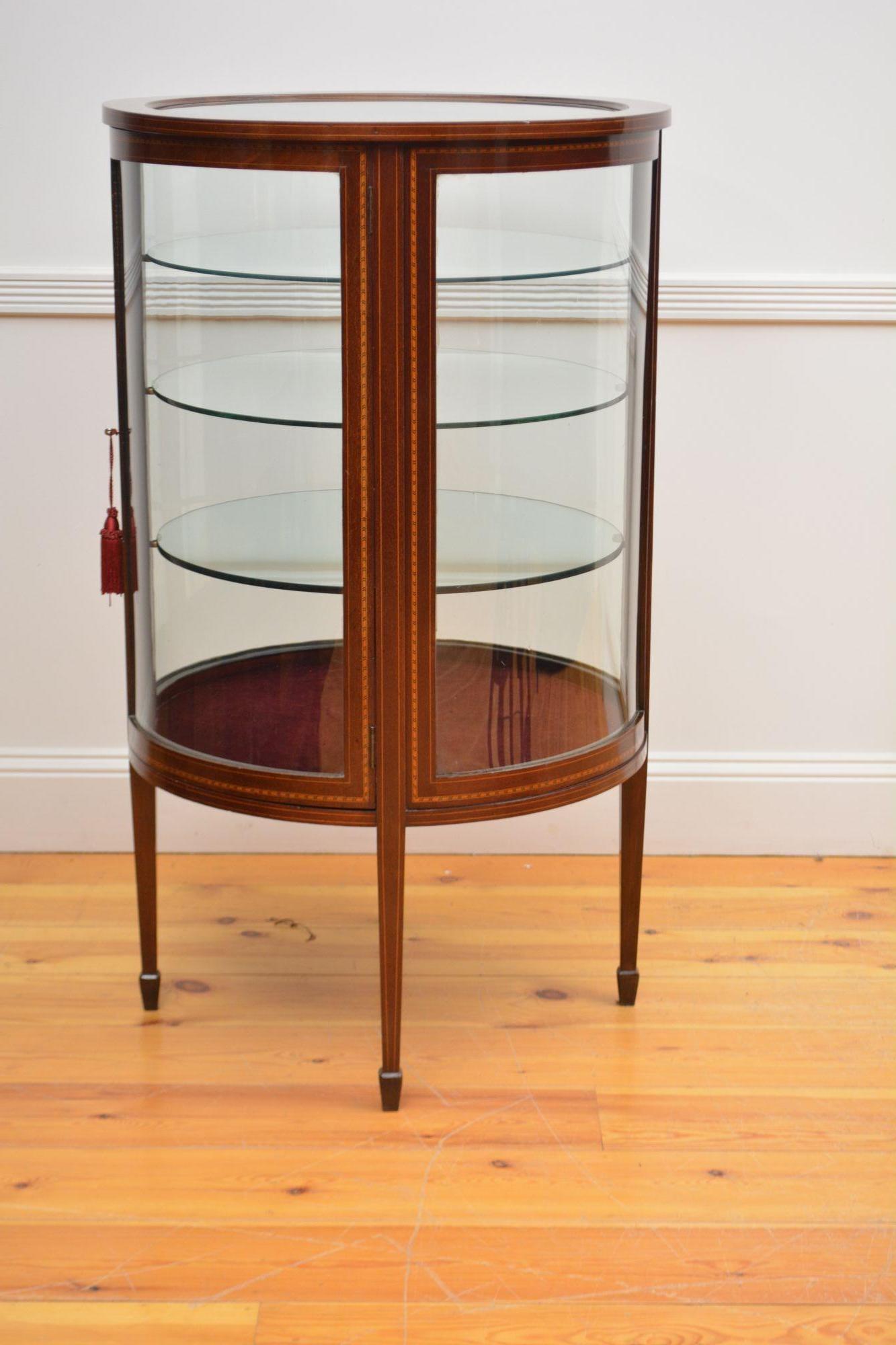 Sn4427 Rare and very unusual Edwardian cylindrical display cabinet / vitrine, having original bevelled edge glass to inlaid top, inlaid door fitted with original working lock and a key enclosing three glass shelves and newly lined interior, all
