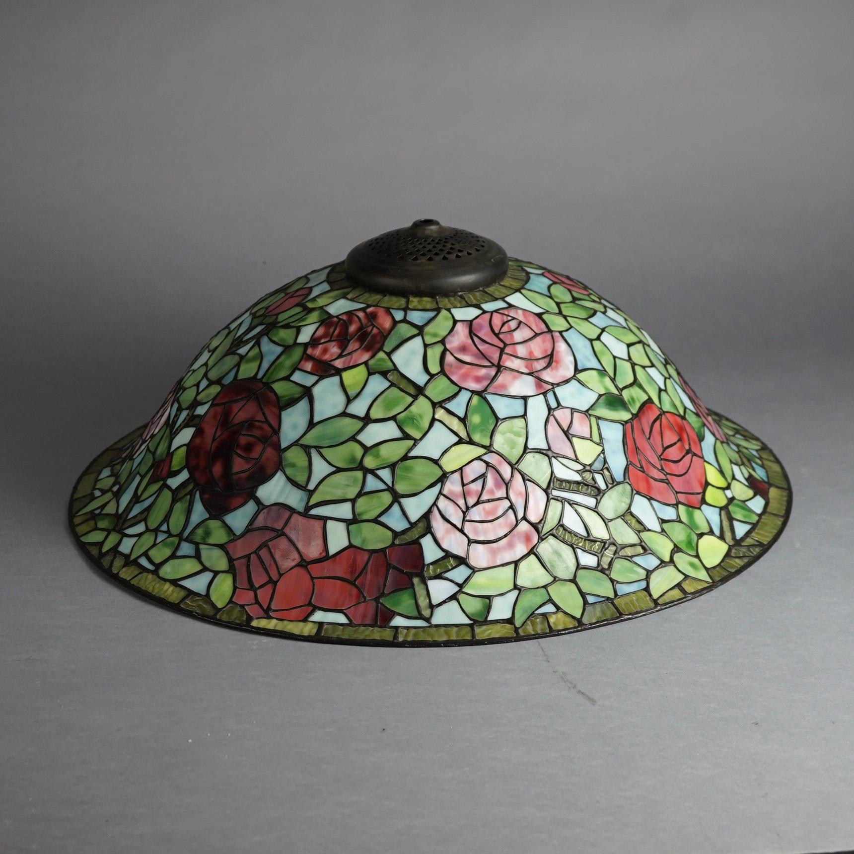 An oversized Arts & Crafts Dale Tiffany Museum Rose Bush table lamp with flared leaded stained glass shade having rose design over triple socket cast tree form base, 20th century

Measures - 34