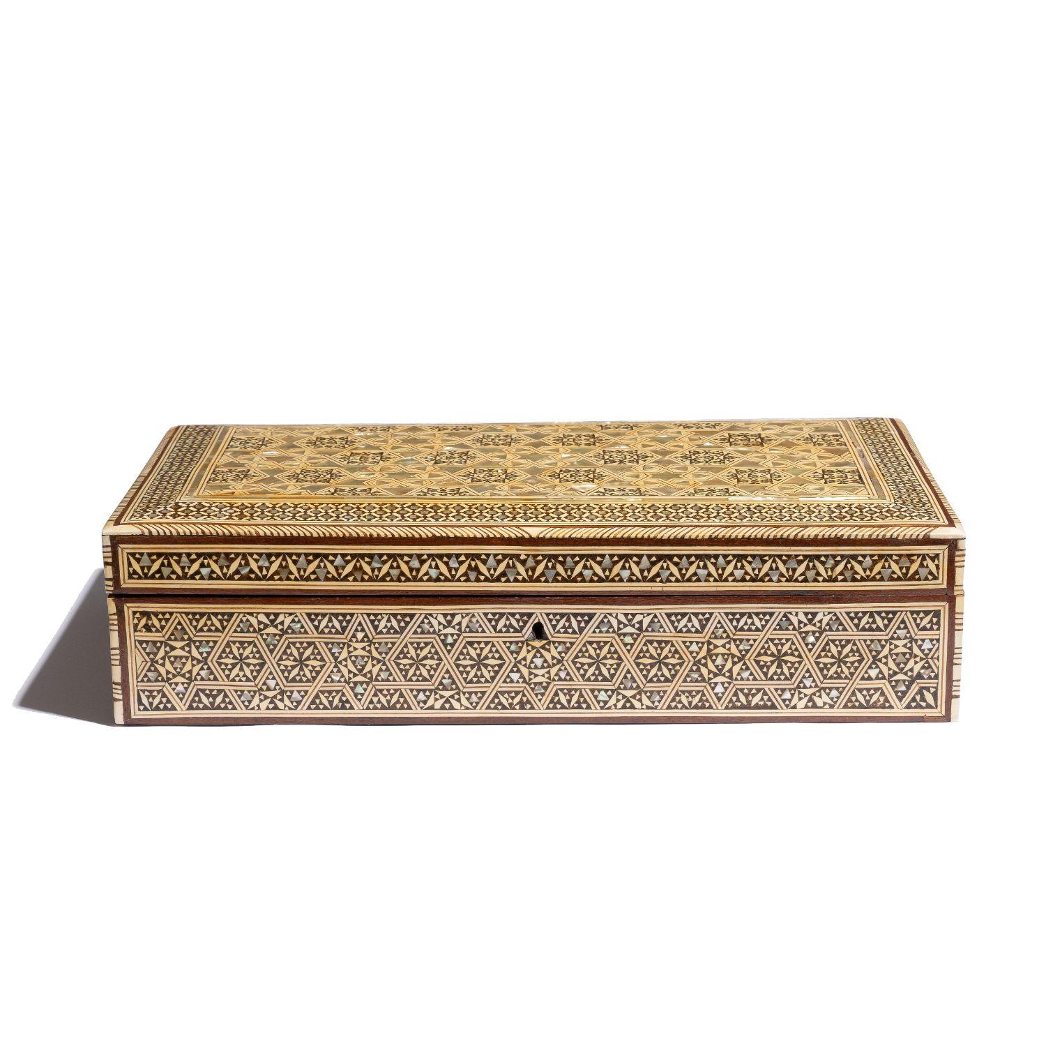 Damascus inlaid rectangular box with hinged lid and covered with matched geometric hexagonal pattern with diapered border. The inlays are composed of sandalwood and ebony with abalone and camel bone on mahogany with a piano hinge. The box is fitted