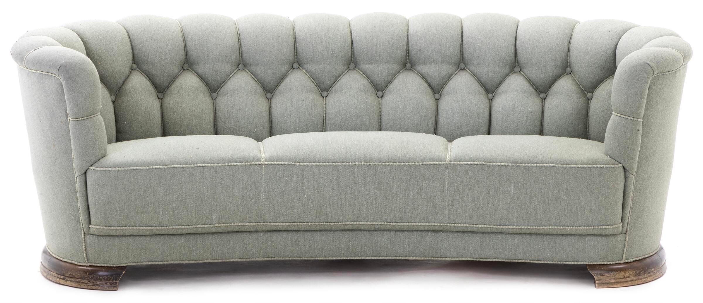 Sizable and very elegant Danish 1930-40s curved sofa raised on a beech frame and legs. These type of sofas was manufactured from the 30's and up through the early 50's. This model is from around 1935-40 and has more Art Deco inspired leg that are