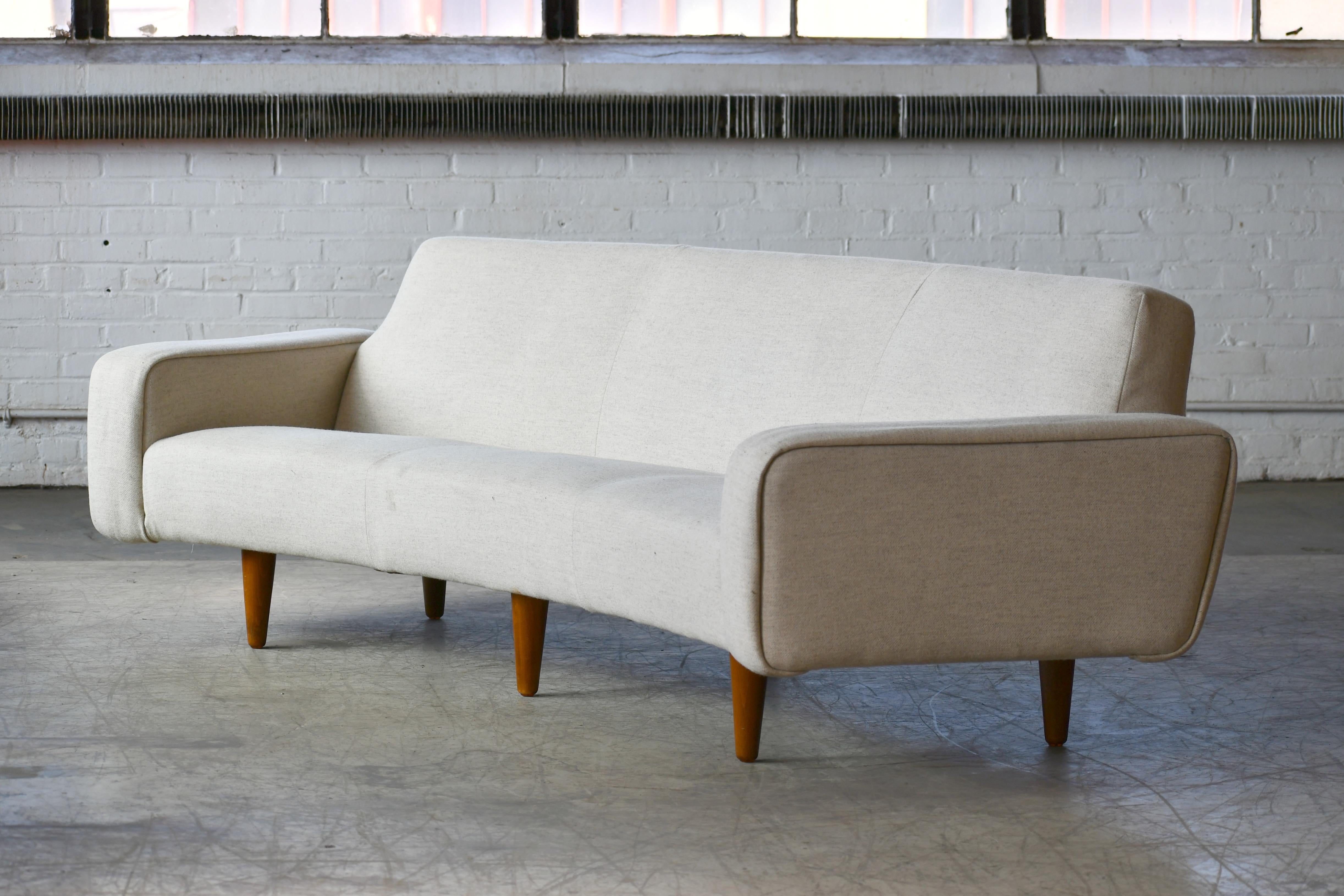 Illum Wikkelso is known for his fantastic sofa and chair designs and this rare model 450 sofa designed in 1958 and manufactured by Aarhus Polstrings Møbelfabrik in the 1960s is absolutely one of the finest to come out of the Danish midcentury era.