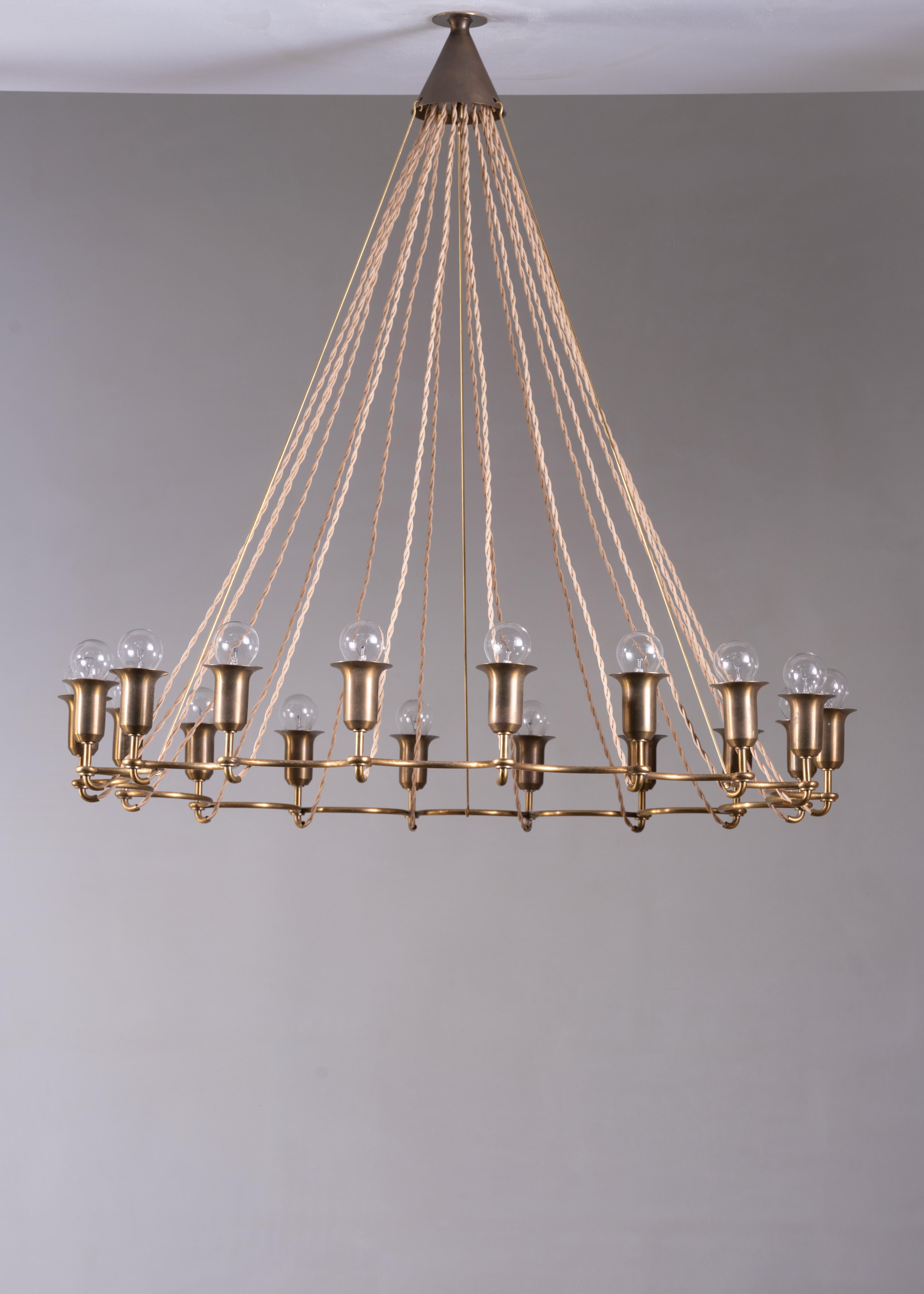 A large (84 cm diameter) Danish chandelier made of patinated brass with 18 sockets.

The wires come together in a cone shaped brass ceiling cap and the large circle is stabilized with nearly invisible long pens, going from the circular frame to the