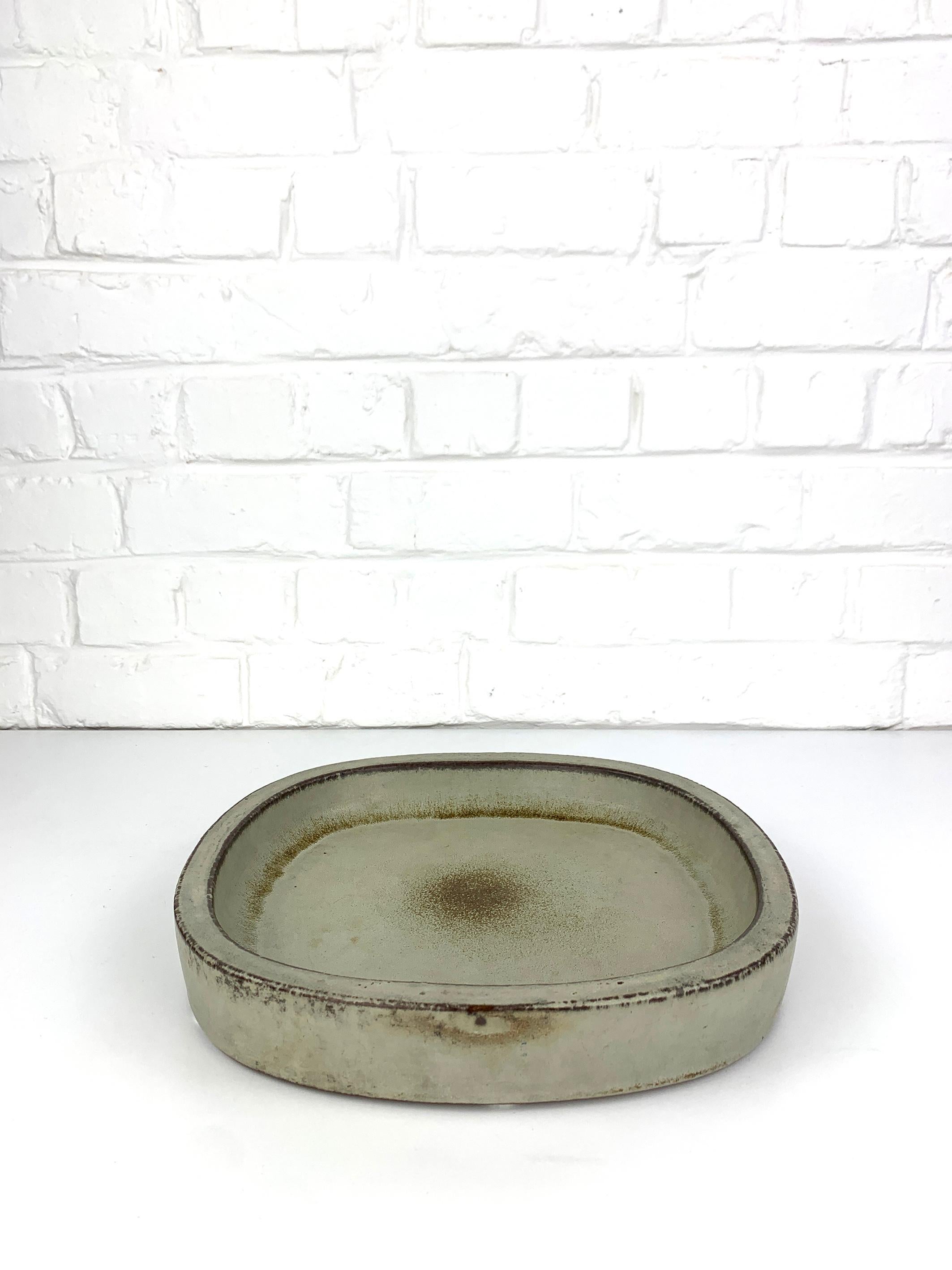 Large ceramic vide-poche or low bowl in earth tones beige-grey brown. Square with rounded edges. 

Scandinavian Mid-Century 1960s, produced by Palshus (Denmark), founded by Per and his wife Annelise Linnemann-Schmidt. 

The couple created and