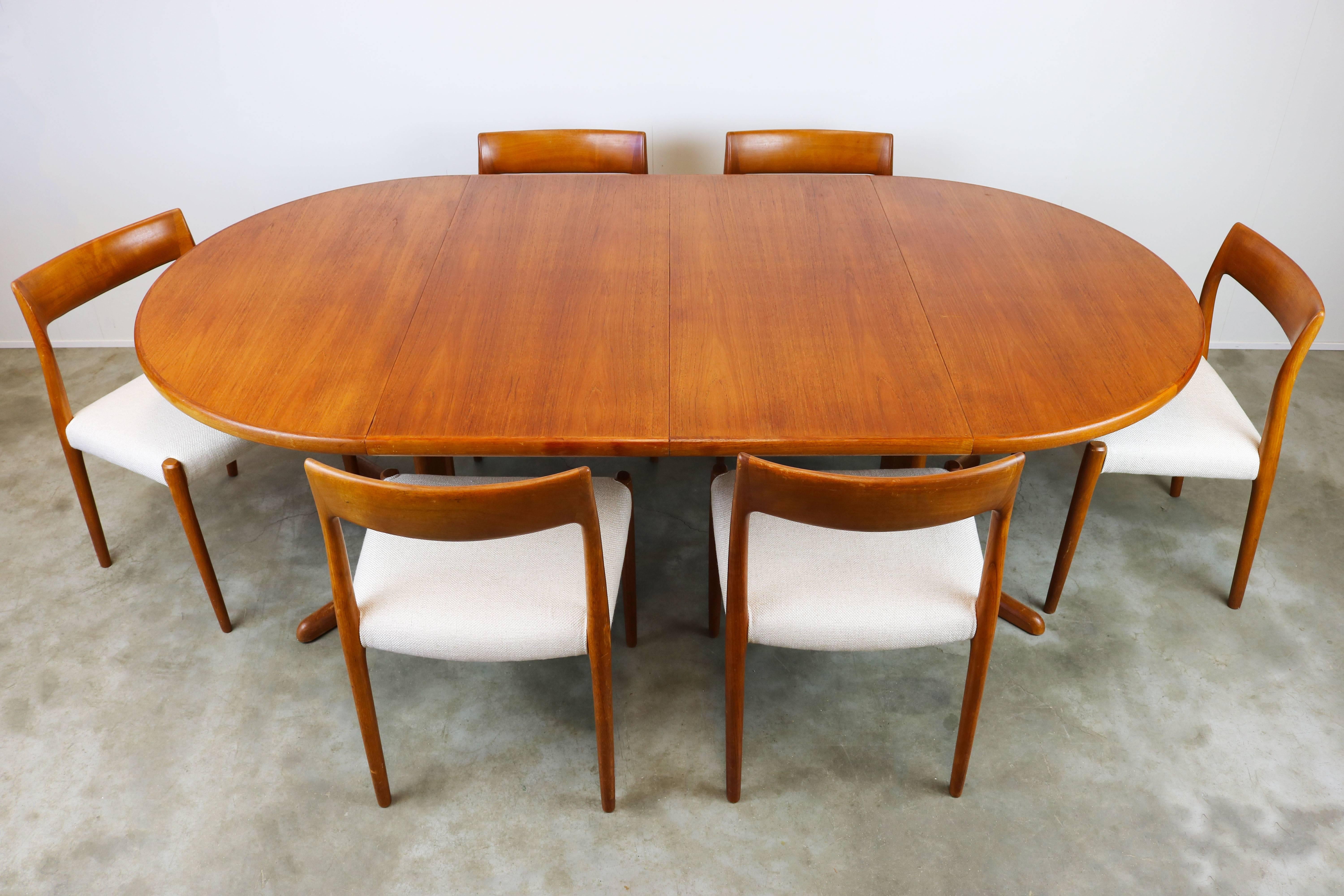 Large dining room set designed by Niels Otto Møller and produced by J.L Mollers in the 1950s. The set has six model 77 chairs in teak and a large round (twice extendable) table in teak.
The table can be used round for four persons. Extended once