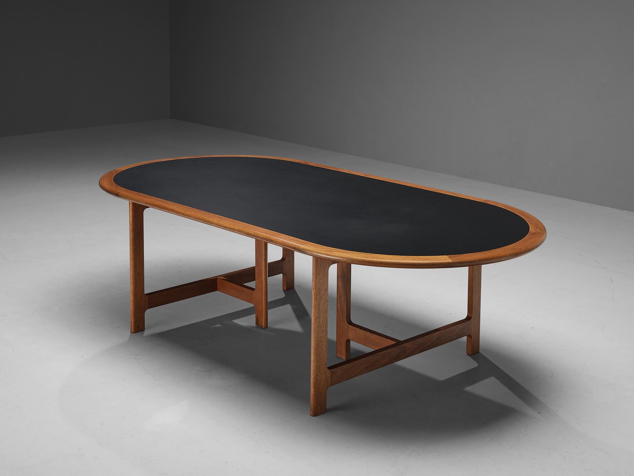 Dining or conference table, teak, vinyl, Denmark, 1960s. 

Sizeable dining or conference table executed in teak and furnished with a black vinyl table top. Characteristic for this design are the flat rectangular table legs, attached by a wooden