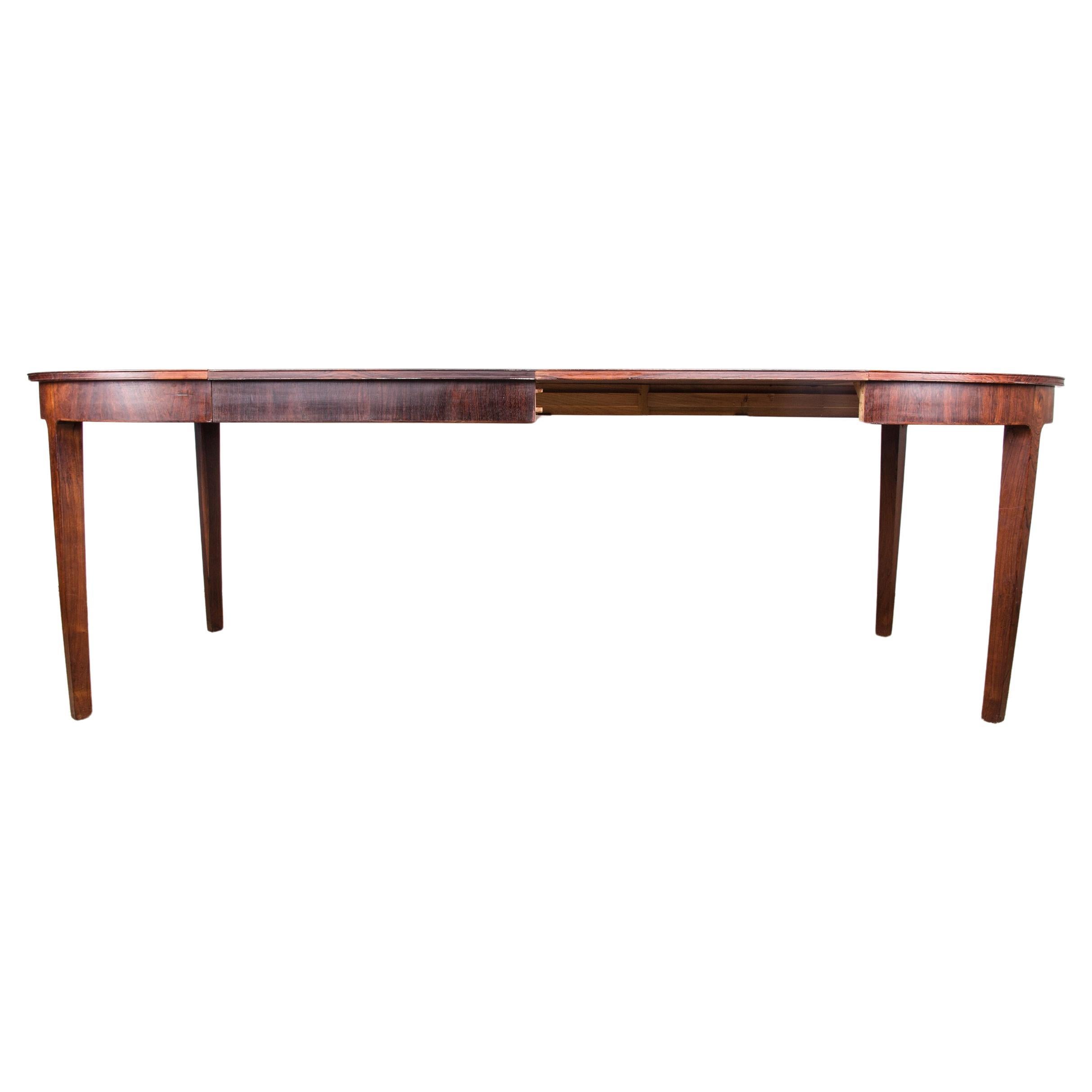 Large Danish extendable dining table in Rosewood by Hugo Frandsen for Spottrup. For Sale