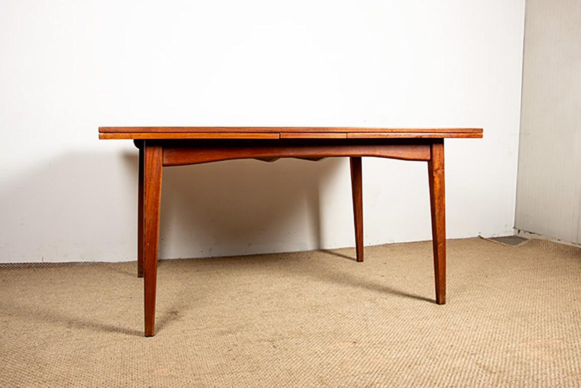 Superb Scandinavian dining table. Two 60 cm Italian-style extensions on each side, which fold away in one movement, allow it to seat up to 12 people. This piece of furniture boasts a simple and elegant design and is beautifully crafted. Listed in