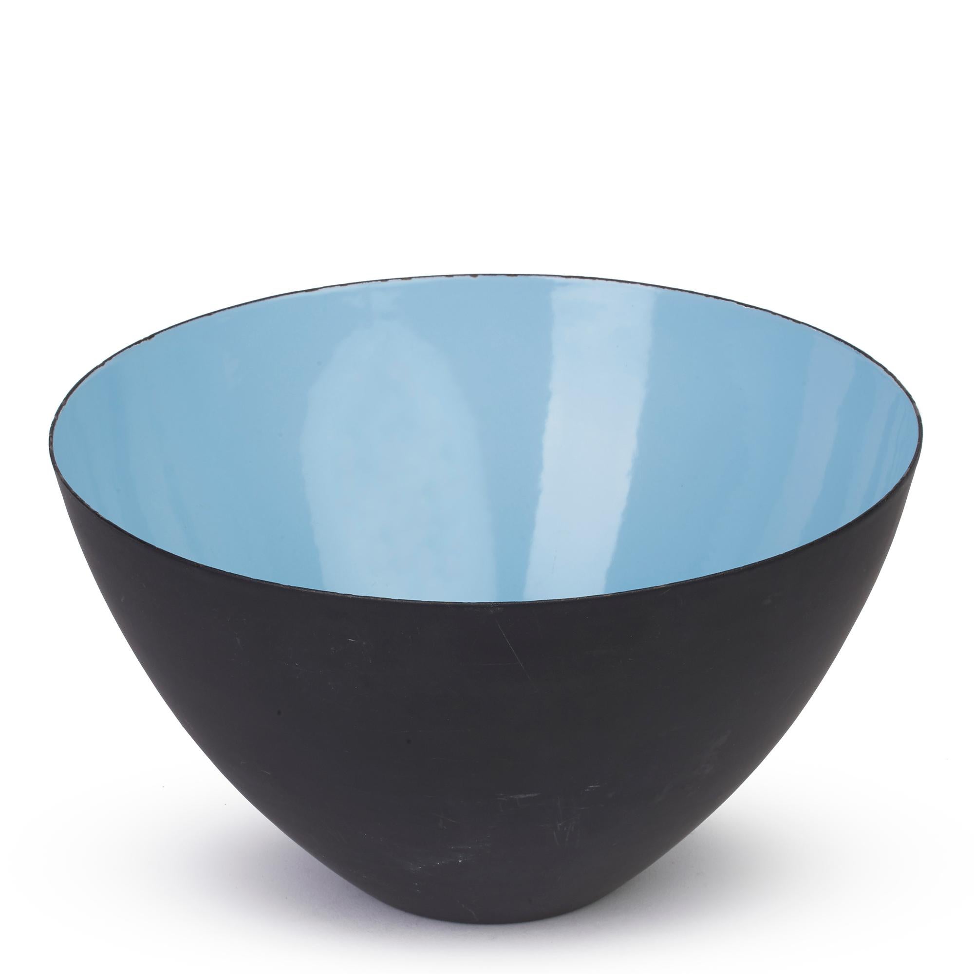A stylish and large Danish Krenit Turquoise enameled black metal bowl designed by Herbert Krenchel and dating from the 1960's. The bowl stands on a narrow flat rounded foot and is of deep rounded form with the inner bowl decorated in bright