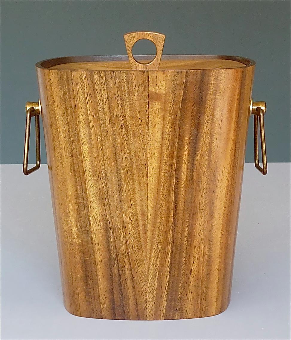 Large signed Scandinavian Modern ice bucket or wine / champagne cooler with handles and lid designed and executed probably in Denmark circa 1950s. This midcentury beauty is made of a rounded square wood corpus with lid, probably walnut or teak, cool
