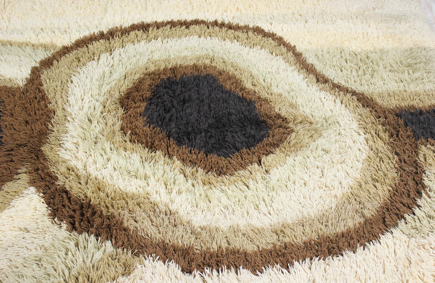 Large rug designed by Carin Agner Nielsen for Ege Rya in Denmark circa 1960’s. Crafted by Denmark’s most successful rug producer, this unique and decorative Nordic design features a hand-knotted wool technique with a circular design in earthy tones