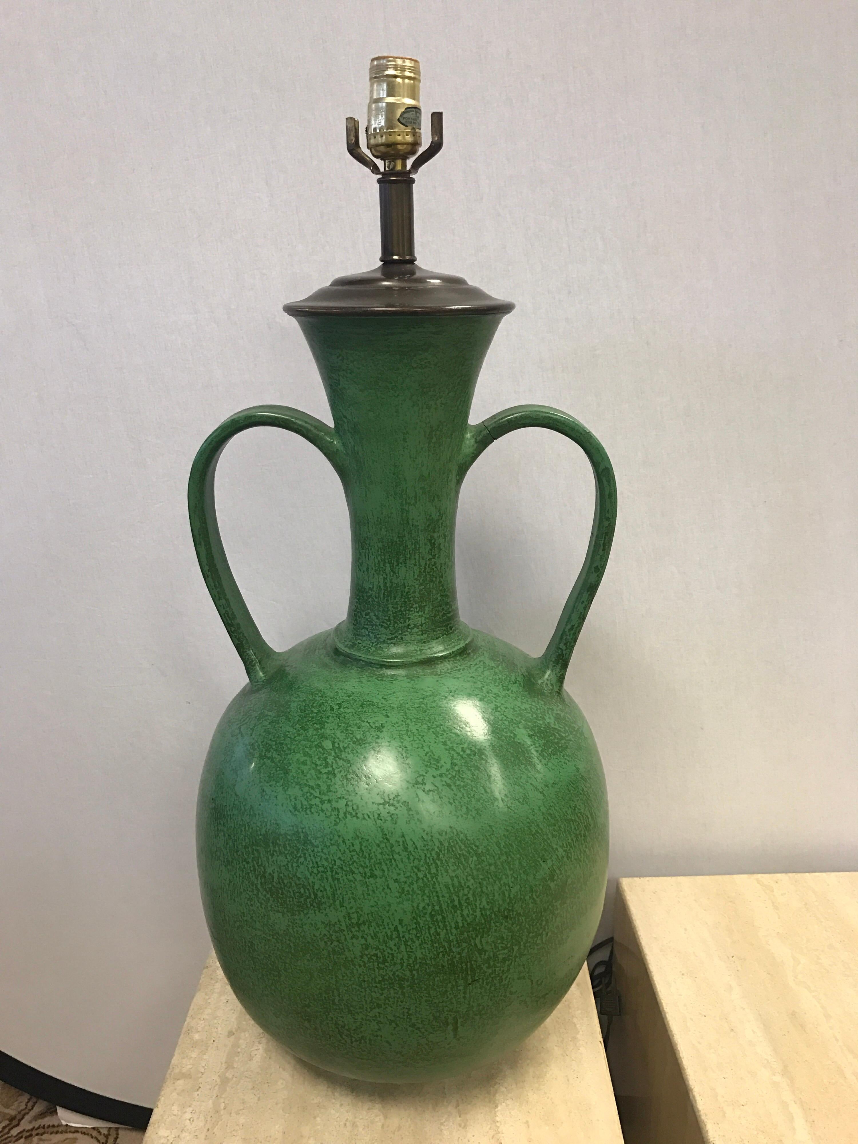 Danish modern tall table lamp in a green glaze. All original. Condition is very good save for a repair on one of the arms/handles.