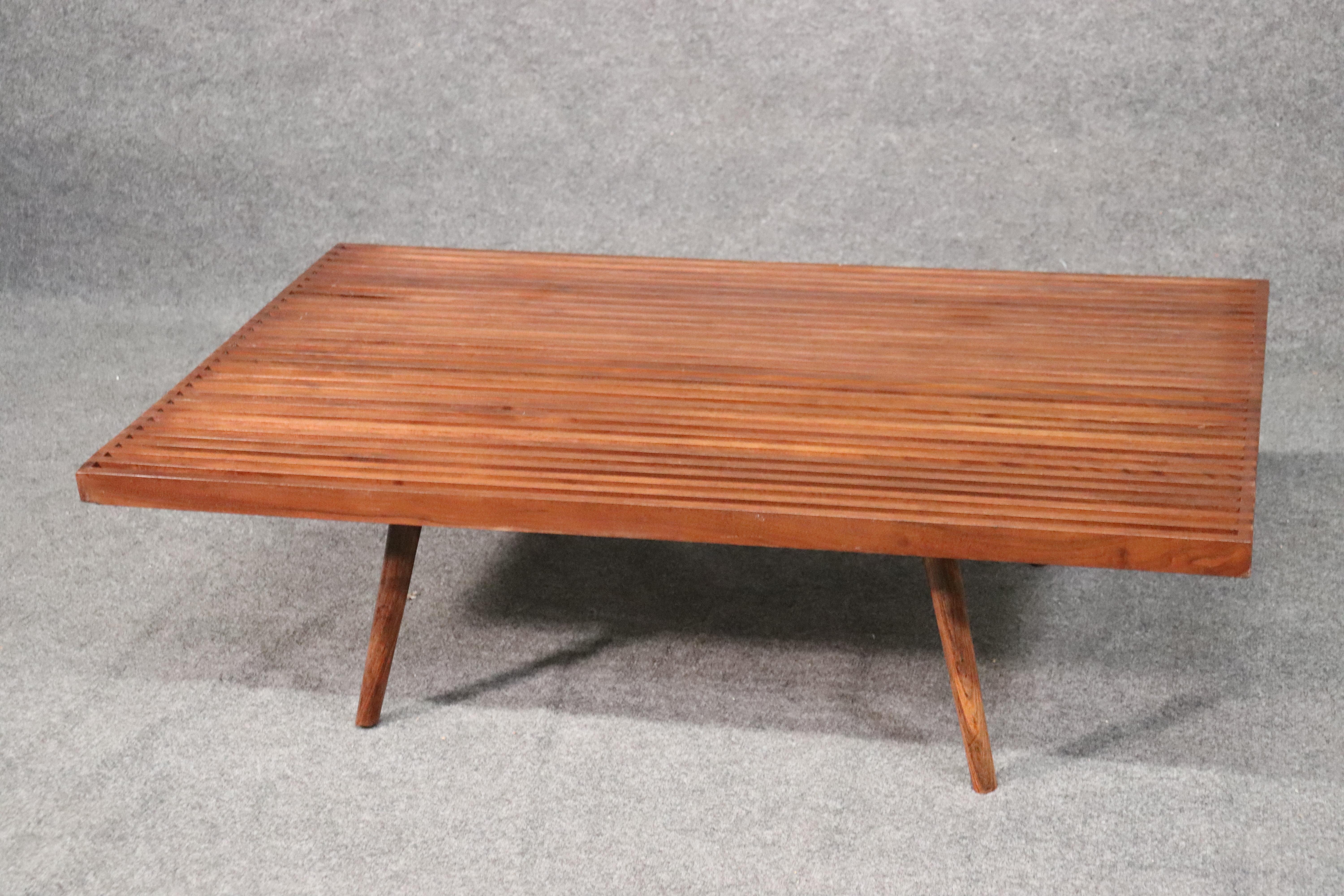 This is a beautiful teak coffee table. The table has splayed legs and a great slat top. The table measures: 48 wide x 30 deep x 14 inches tall. This table will work very well with low Danish or other Mid-Century Modern sofas. Dates to the 1960s era.