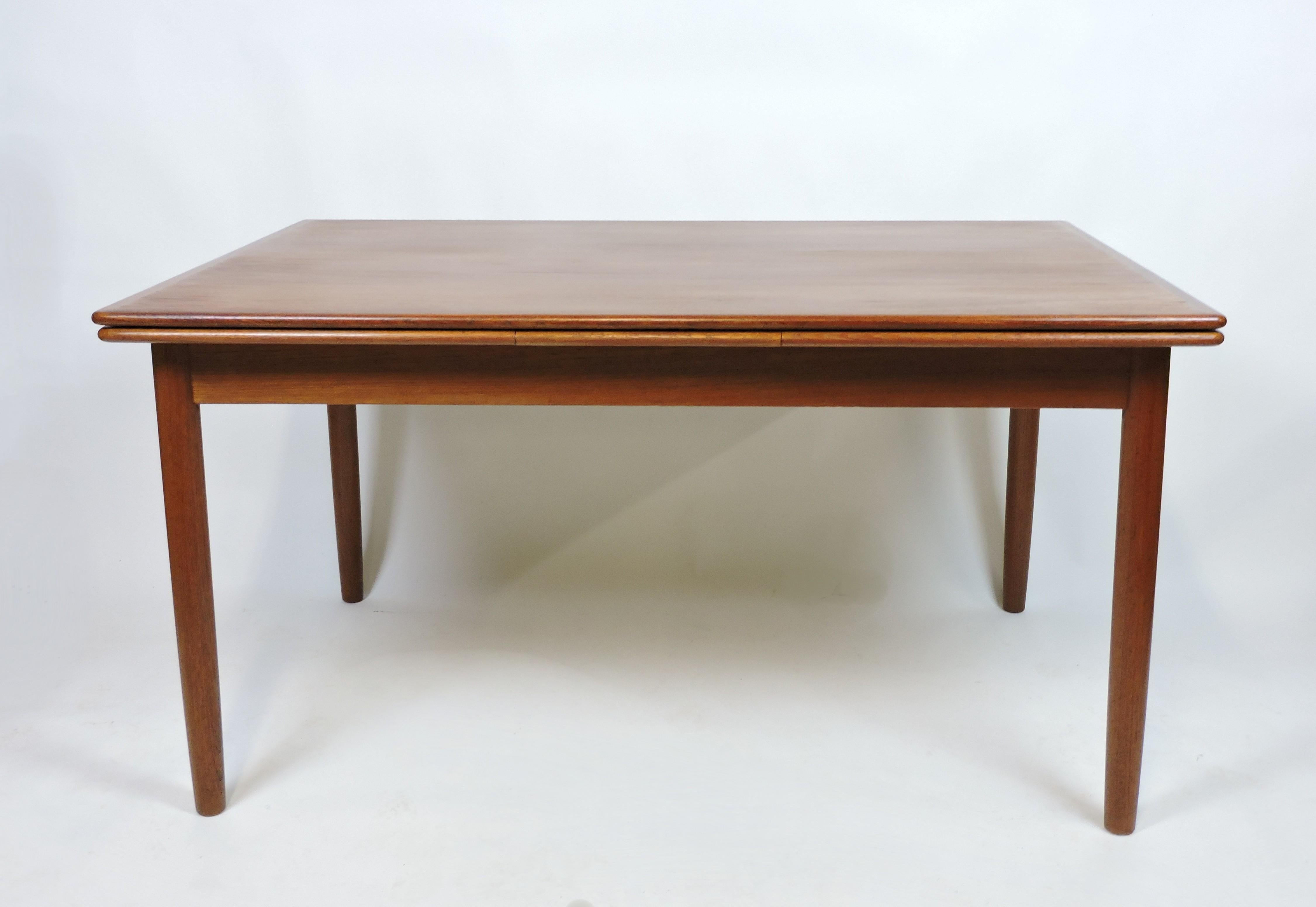 Beautiful teak dining table manufactured in Denmark. This table has solid teak tapered legs and two pull out leaves that extend the surface area from 55 inches to a large size of 97 inches. 
 