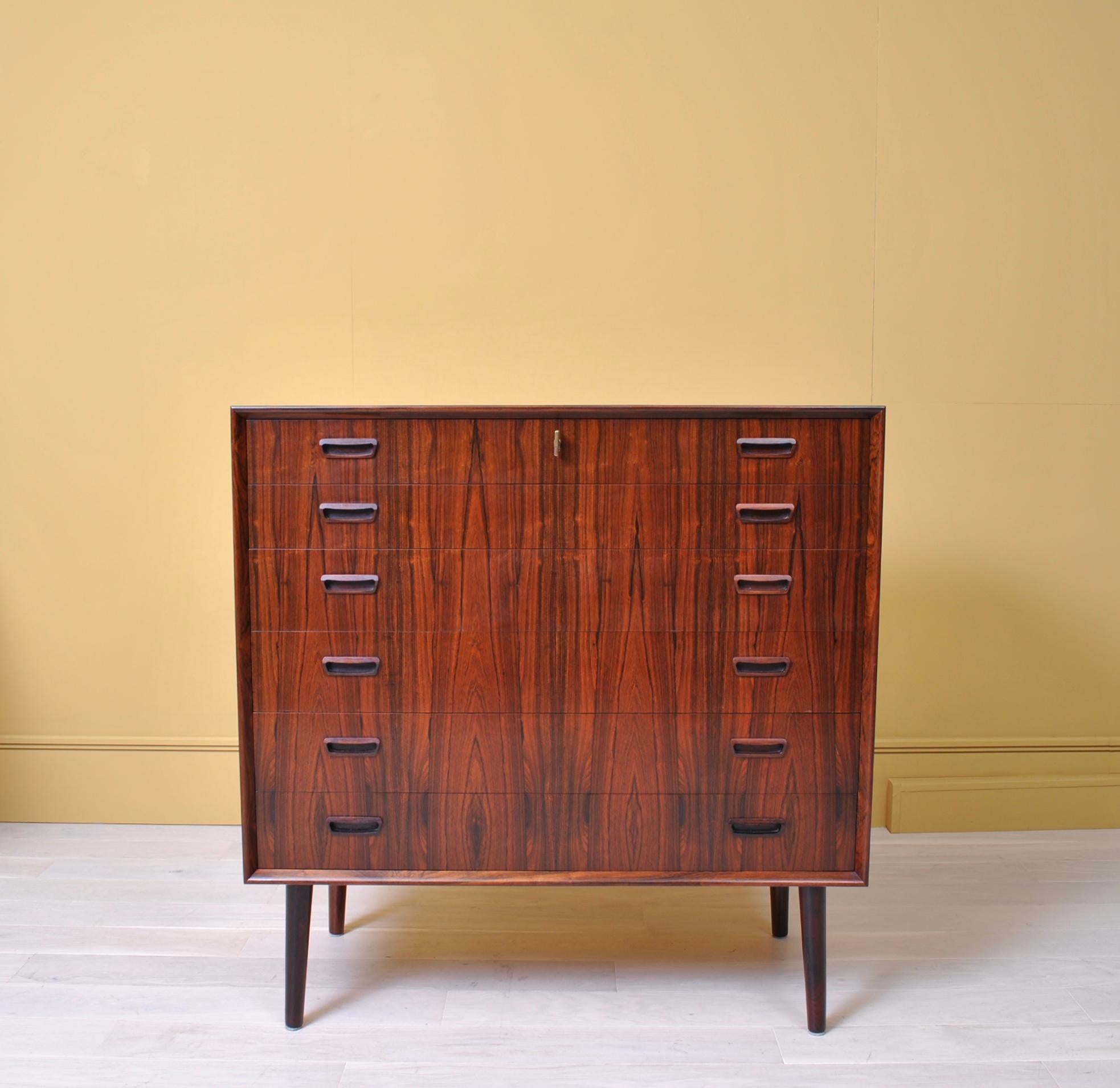 A large and very good quality Danish rosewood midcentury chest of drawers. Original key for lockable top drawer. Well made and very nicely conceived piece of Scandinavian Modern furniture.