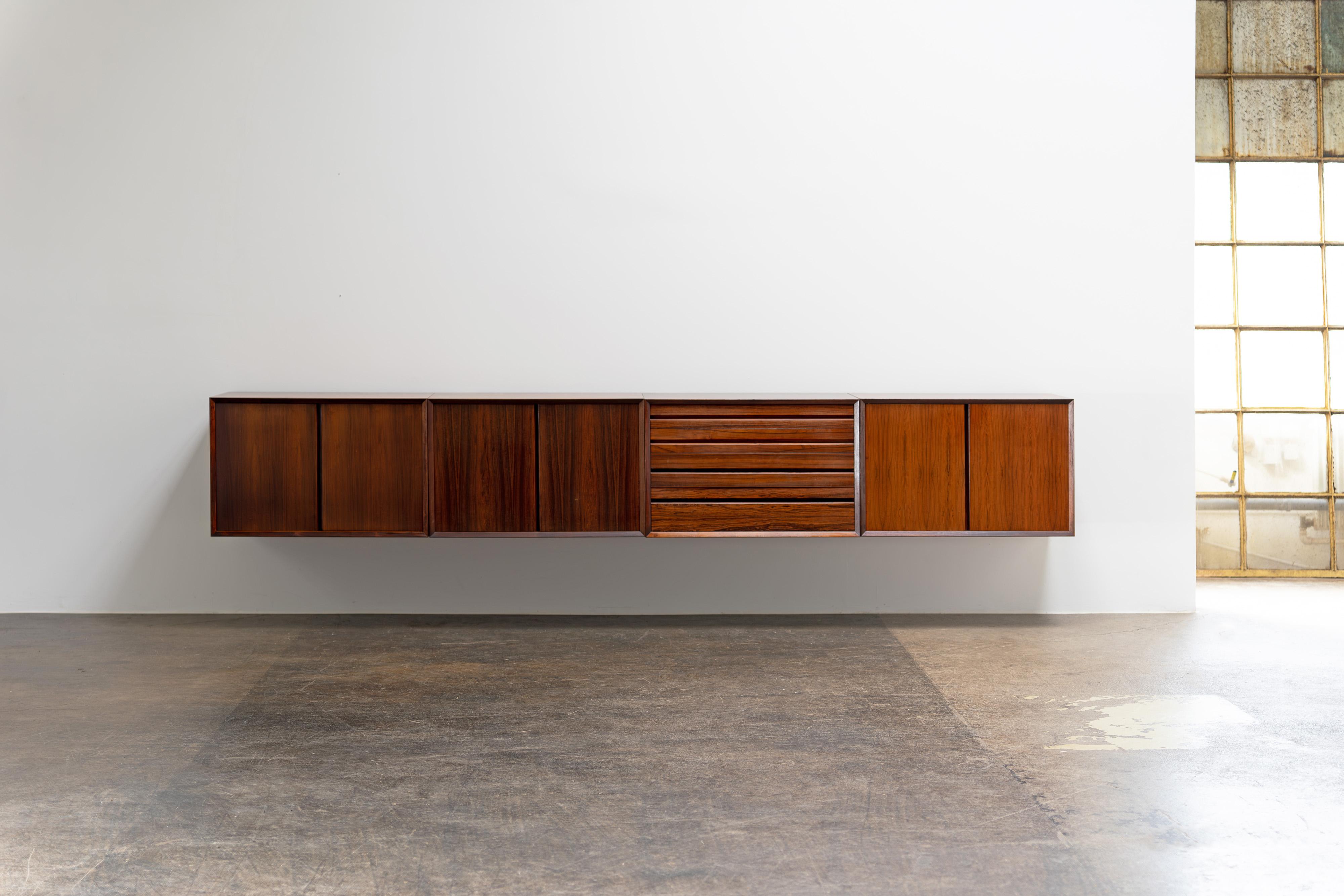 Wall-mounted sideboard by Poul Cadovius from the 1960s. The sideboard consists of three cabinet modules and one drawer module and is veneered with high-quality rosewood. We have a CITES sales permit for this piece and it will be passed on to the