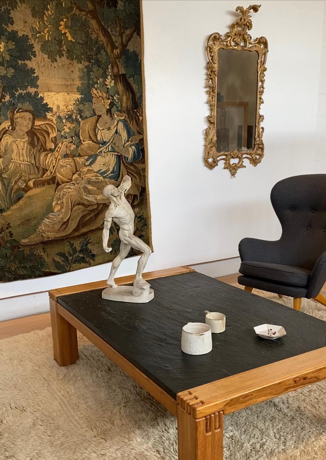 The design details that make this table so unique are few but powerful: the sculptural finger joints that hold the pine frame together, the textured surface of the slate top, the contrast between the wood and the stone. This generously proportioned