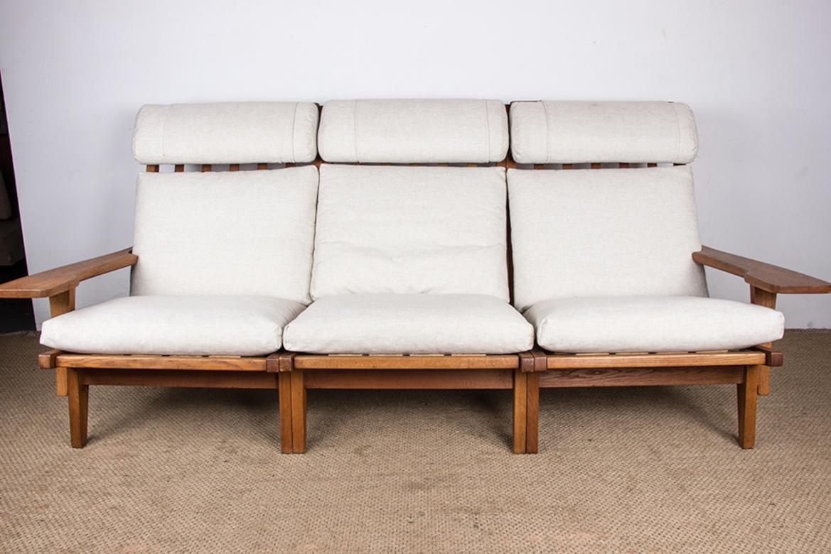 Superb Scandinavian sofa. Composed of 3 high armchairs with movable headrests which form a sofa. V
ery large curved armrests. 
Beautifully crafted piece of furniture with a sober and elegant design. Furniture listed at the Design Museum Denmark.
