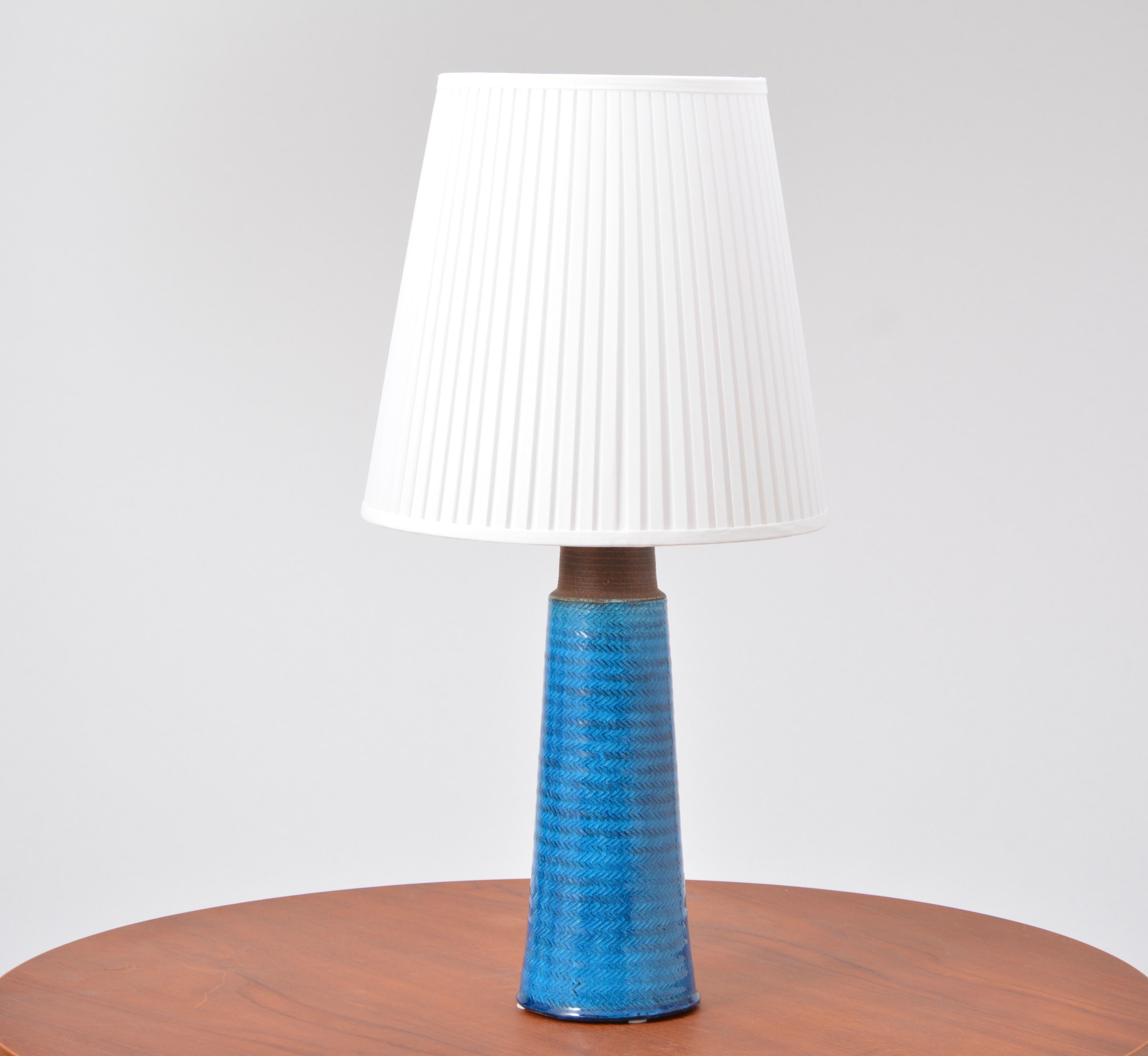 Large Turquoise Danish Mid-Century Modern Stoneware table lamp by Nils Kähler

This stoneware table lamp was designed by Nils Kähler and made in the 1960s by Herman A Kähler Ceramic (HAK) in Denmark. It has a turqouise colored glaze covering. The
