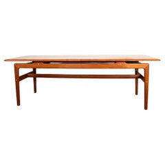 Large Danish teak coffee table with 2 side document holders, 1960.