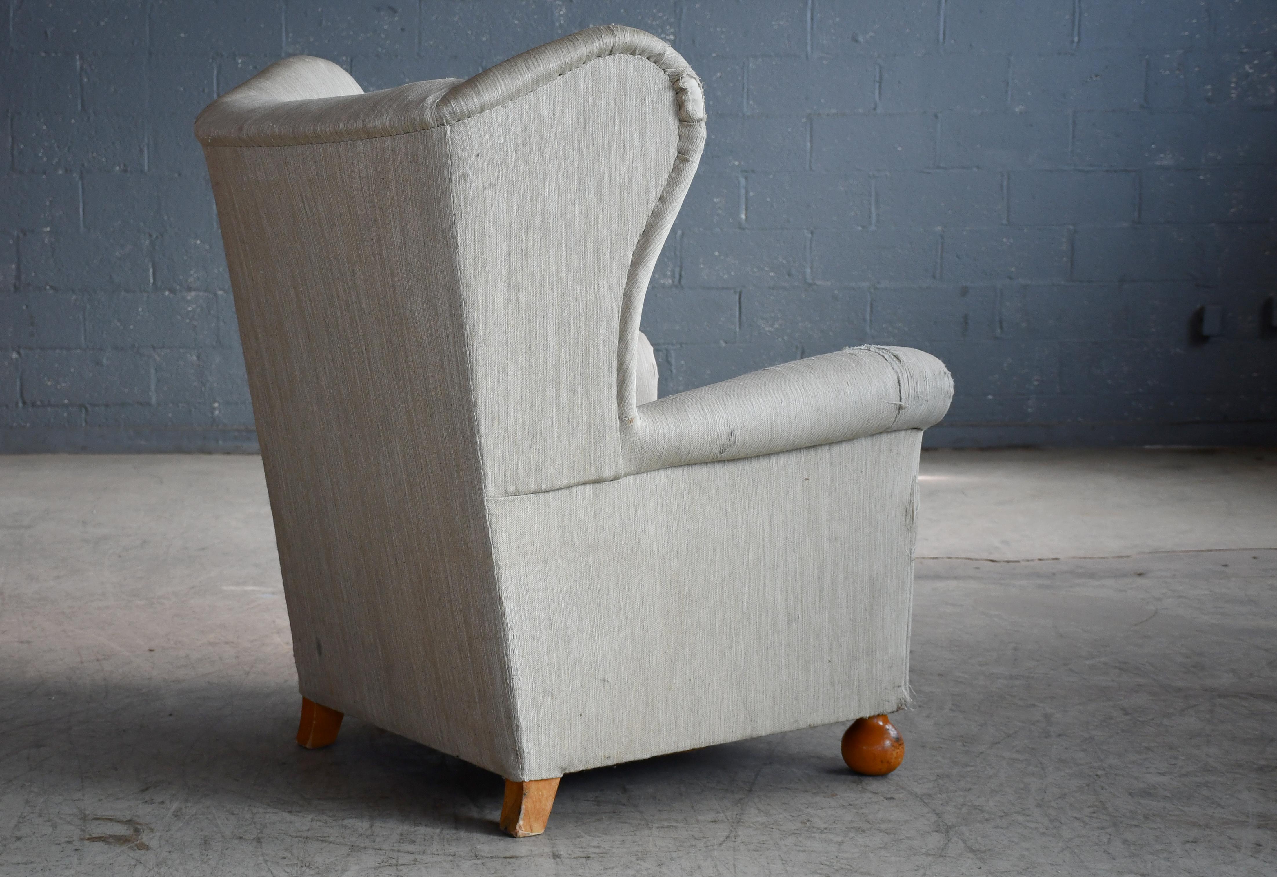 Mid-20th Century Large Danish Wingback Armchair with Bun Feet 1940's For Sale