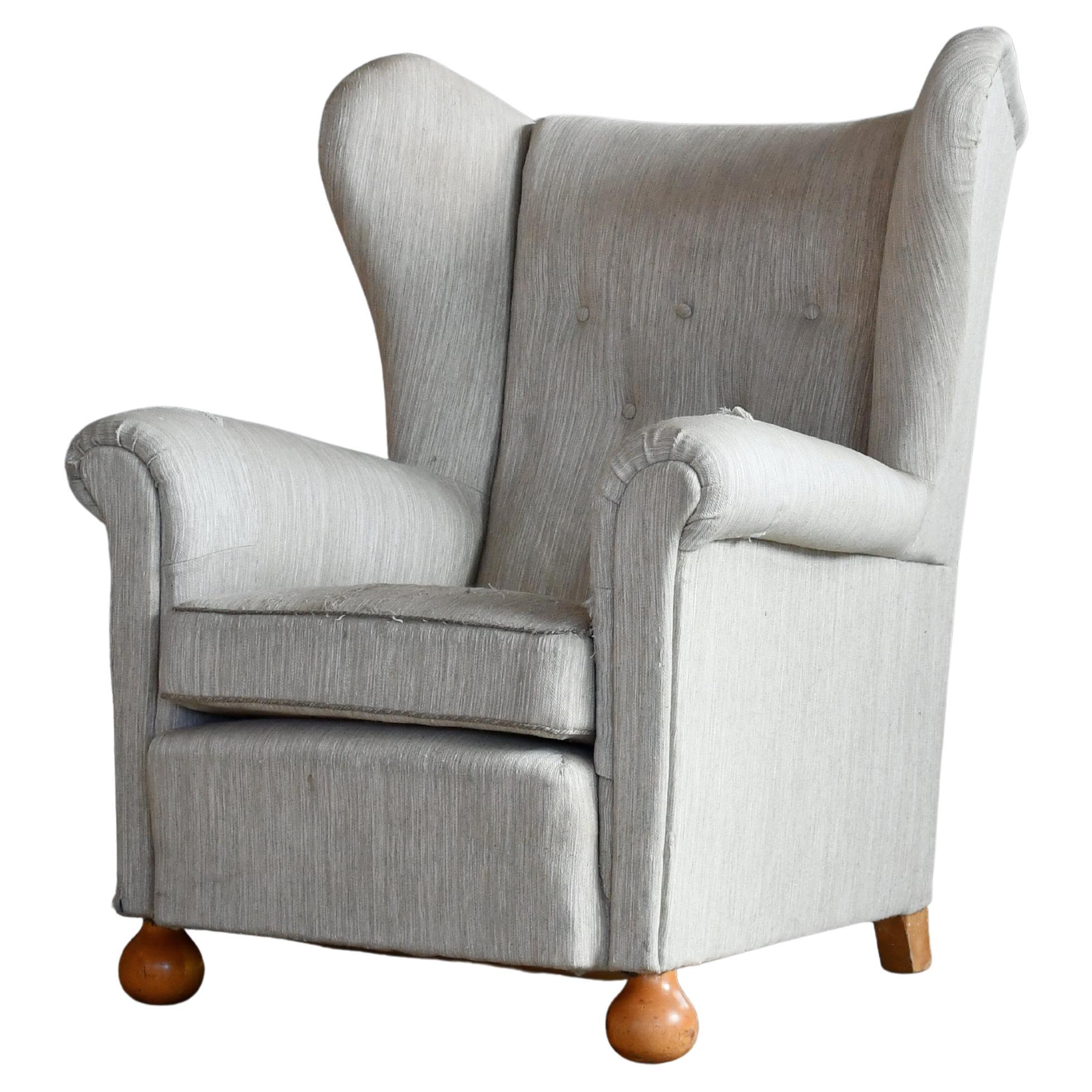Large Danish Wingback Armchair with Bun Feet 1940's For Sale