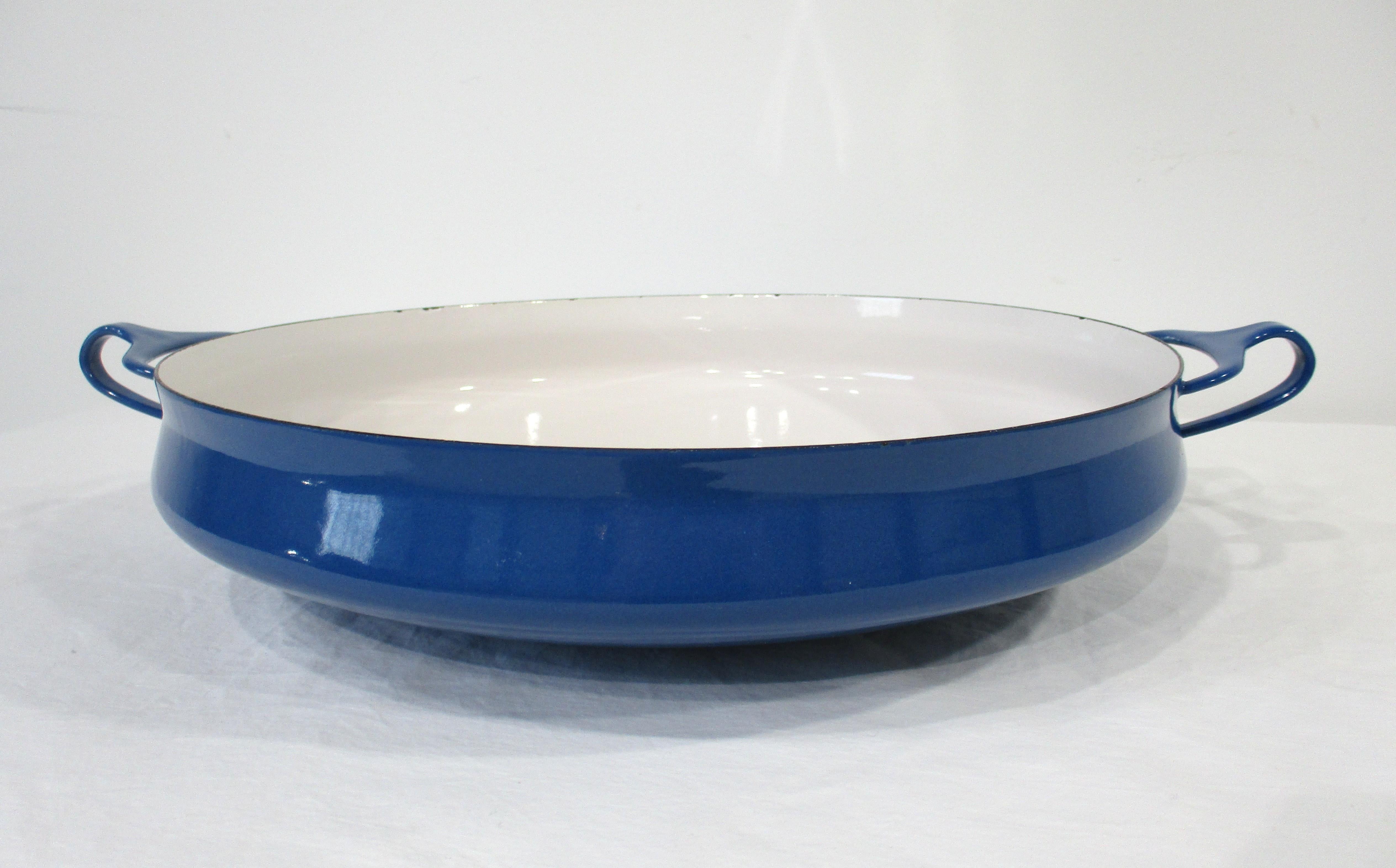 A larger sized bright blue enameled paella / oven Kobenstyled pan manufactured by Dansk known for their quality and simple functionally.  Made in Denmark and designed by Jens Quistgaard this very well-crafted pan would be great for any type of oven