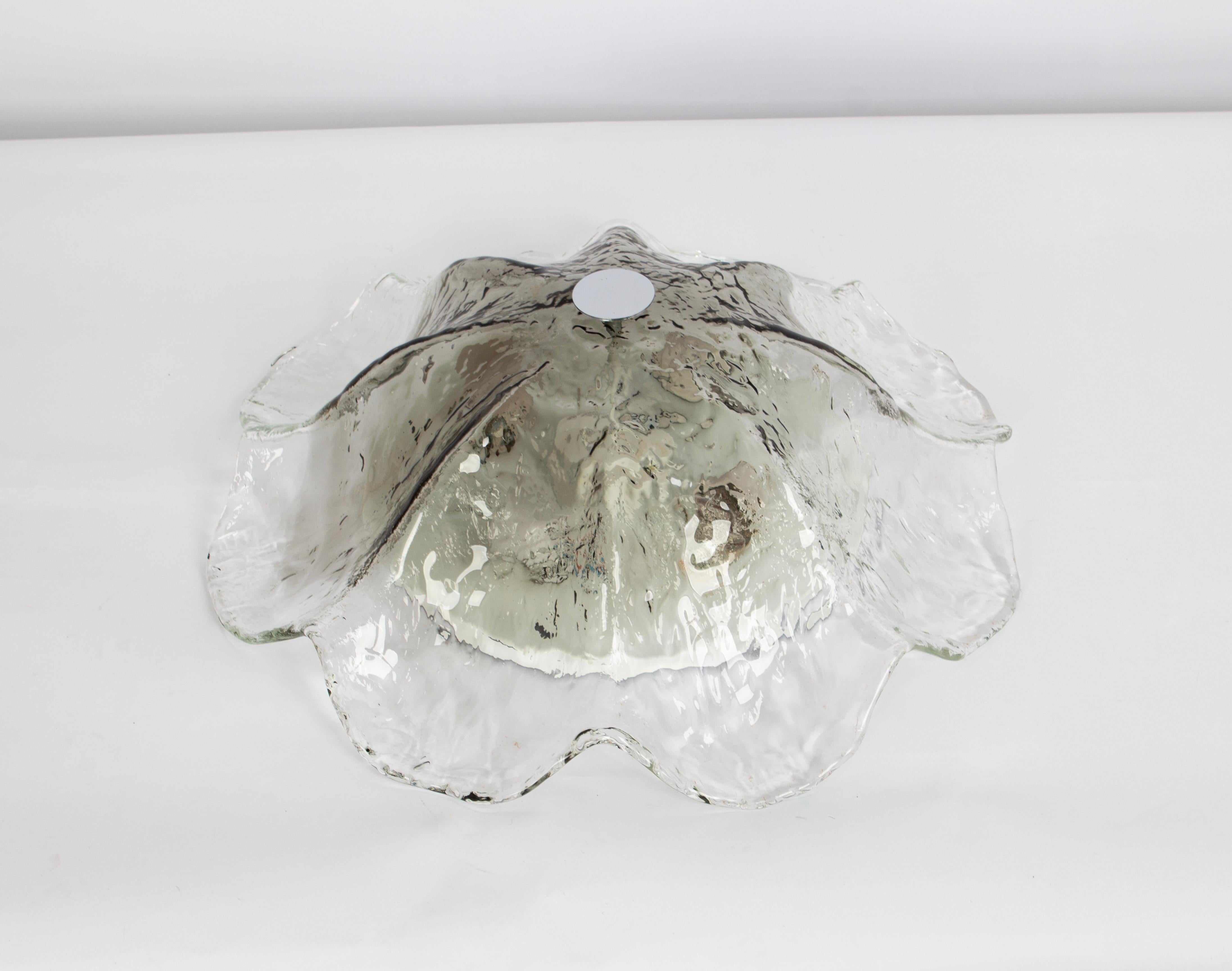 A wonderful round Murano glass flush mount manufactured by Kaiser Leuchten in Germany 1970s.
Thickly Murano textured glass fixture on a white color metal base with a chrome holder.

High quality and in very good condition. Cleaned, well-wired, and