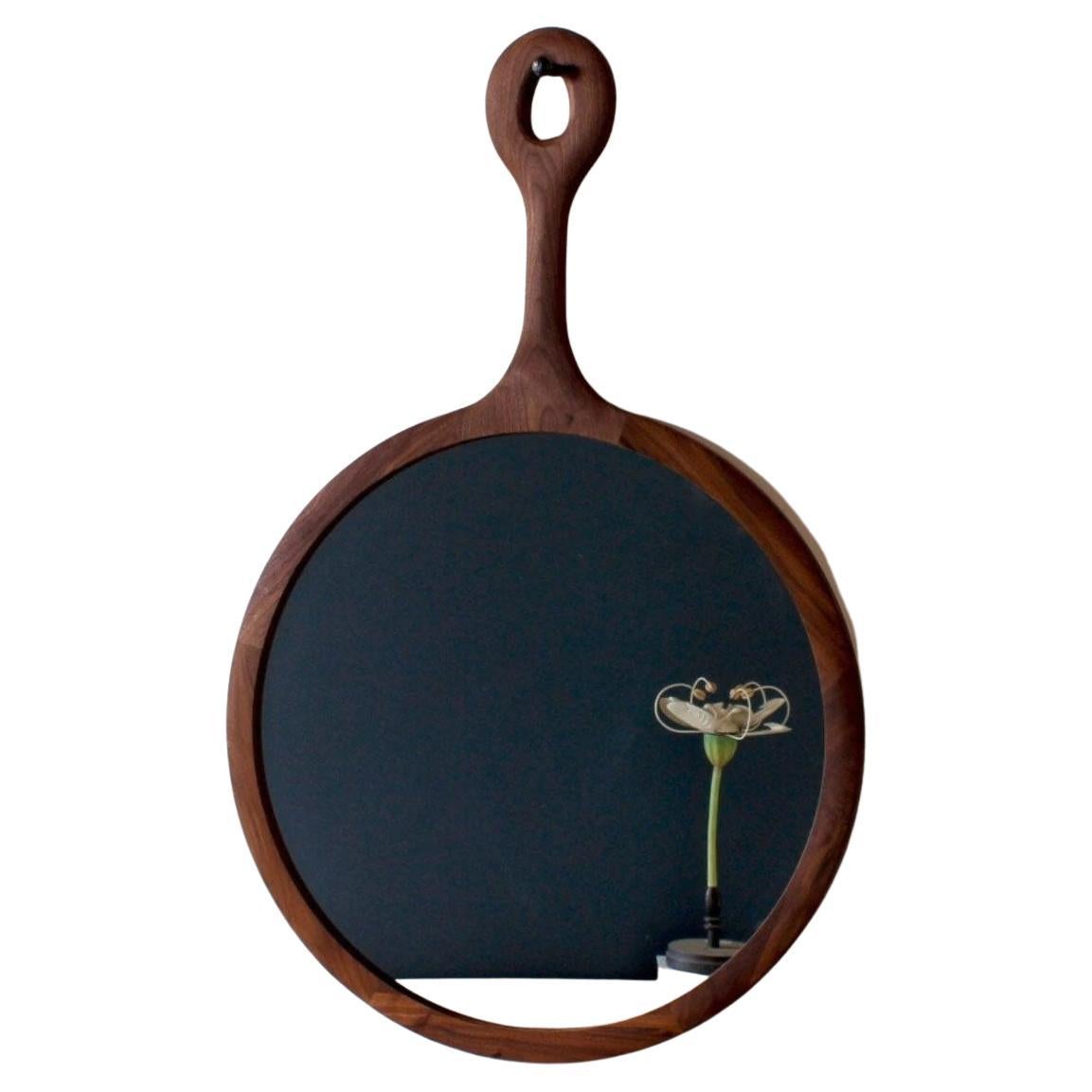 The Sophia mirror is framed in wooden dark maple with a long neck resembling an oversized hand mirror. Handcrafted in Pennsylvania, the Sophia comes with a hand-hammered iron peg for hanging. The medium is a lovely size above a dresser or in a