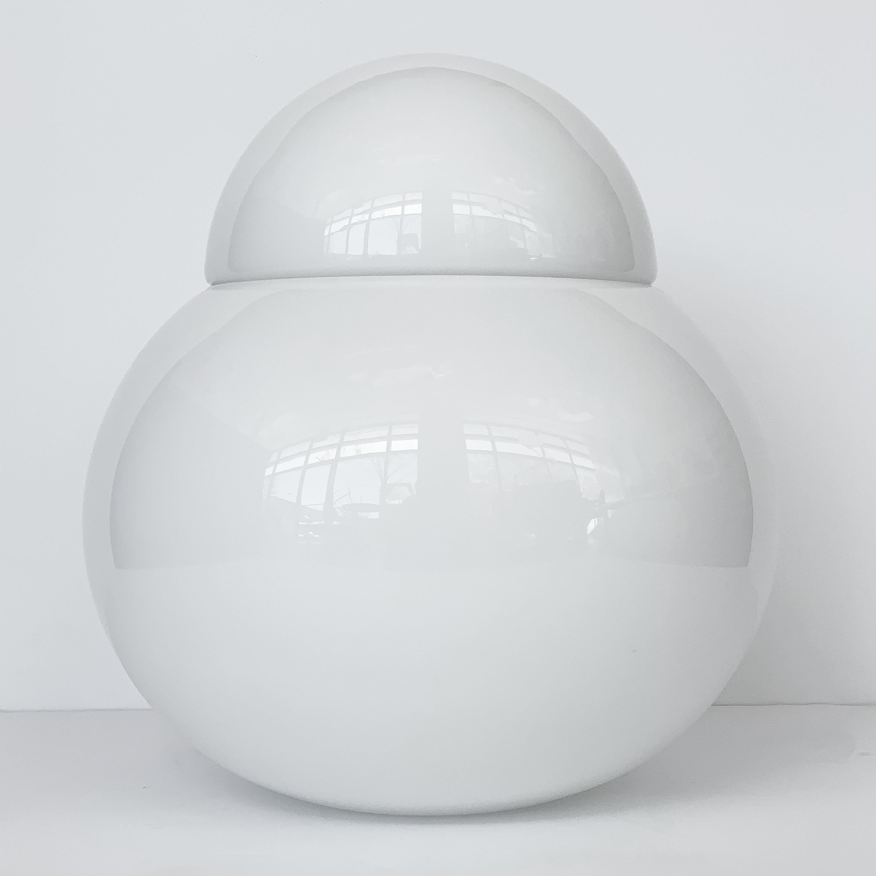 An original large Daruma table lamp designed in 1968 by Sergio Asti for Fontana Arte. The bulbous form of Daruma is simple but casts a unique look and glow to it's surroundings. The diffuser and cap consist of hand-blown polished white glass. Daruma