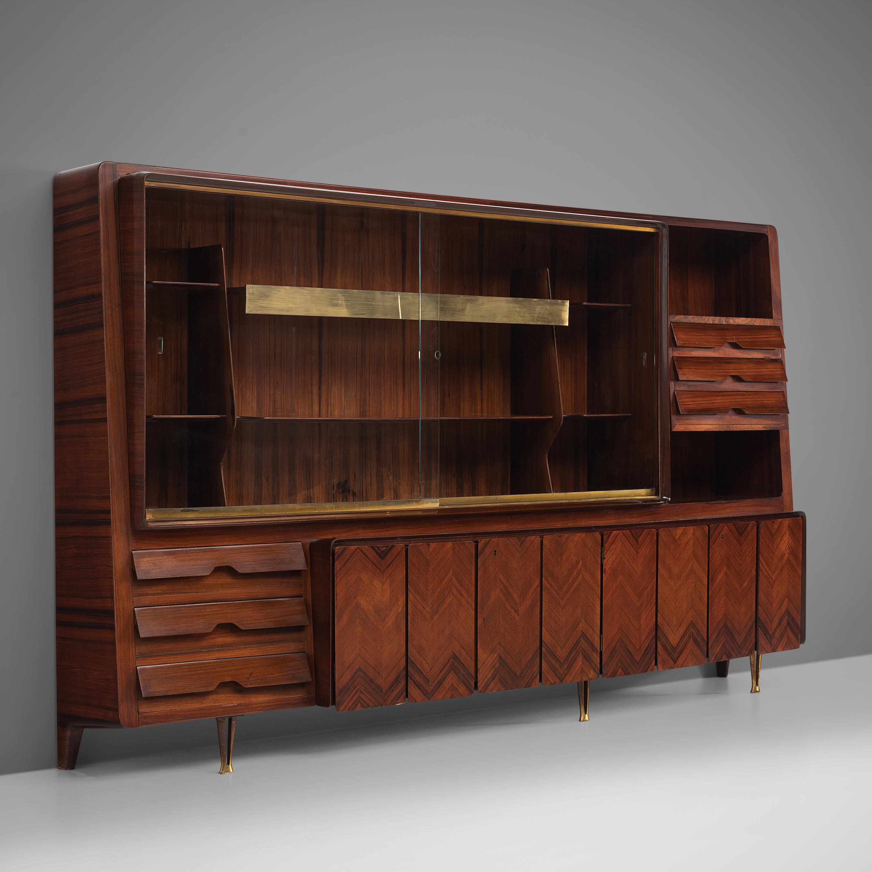 Dassi cabinet, wood, brass, Italy 1950s.

This Italian cabinet is highly elegant and refined. The brass panels, handles and patterned doors are all exquisitely produced. There are closed compartments such as drawers and doors and there are two