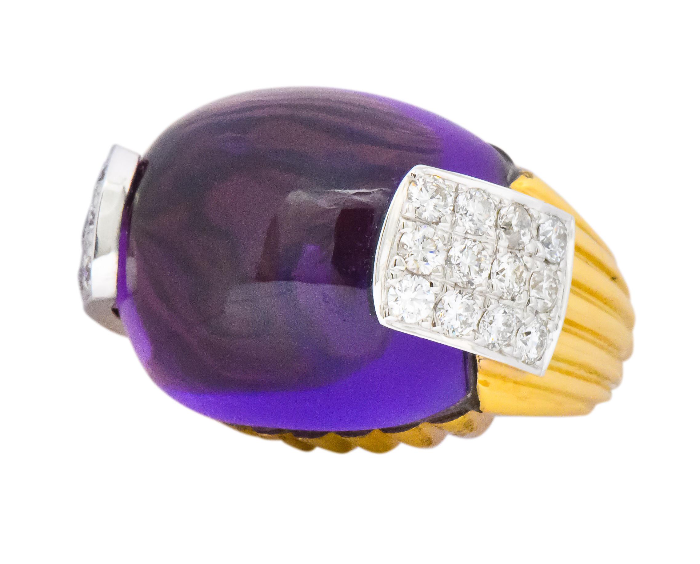 Centering a rectangular cabochon amethyst measuring 23.5 x 19.8 x 12.8 mm, bright vivid purple

Flanked by pavé set round brilliant cut diamonds, weighing approximately 1.55 carats total, G/H color and VS to SI clarity

Bright fluted gold mount