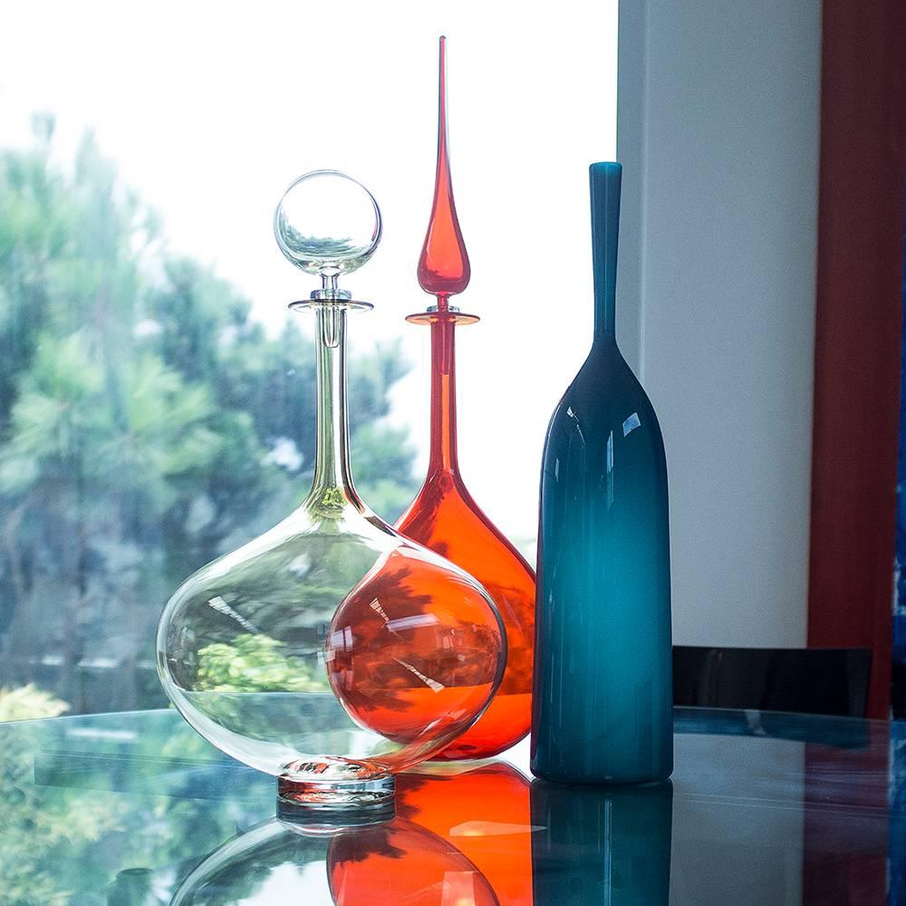 The large decanter genie bottle adds bold presence and stunning beauty to your modern interior environment. Inspired by the greats of Mid-Century Modern design, Joe’s blown glass vessels are a study of color, form and function; the result is a