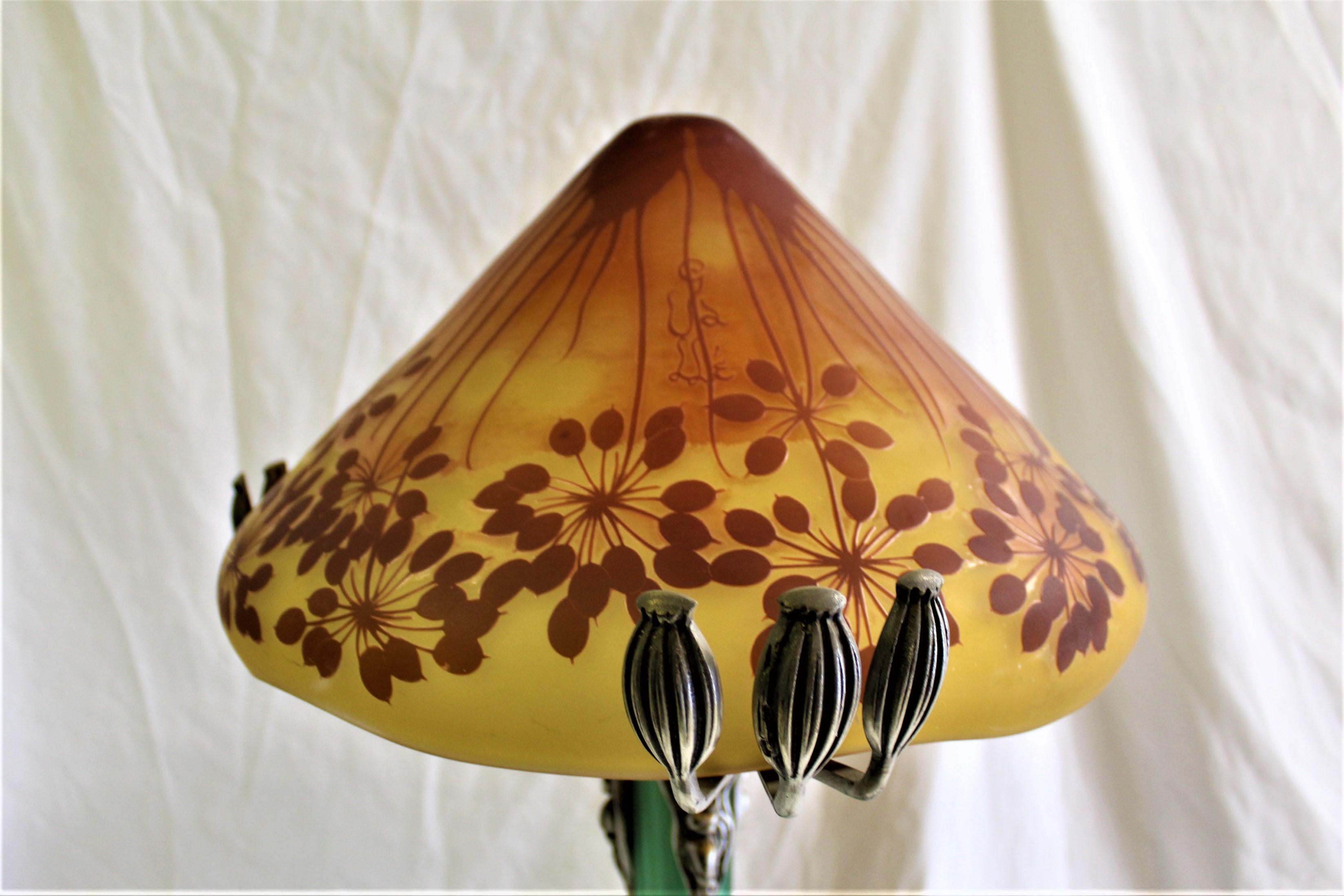 A large glass and bronze lamp in the shape of a Mushroom. Contemporary design from Europe. No longer available and rare to find now. This has to be special white glove packing and shipping. It is at 35