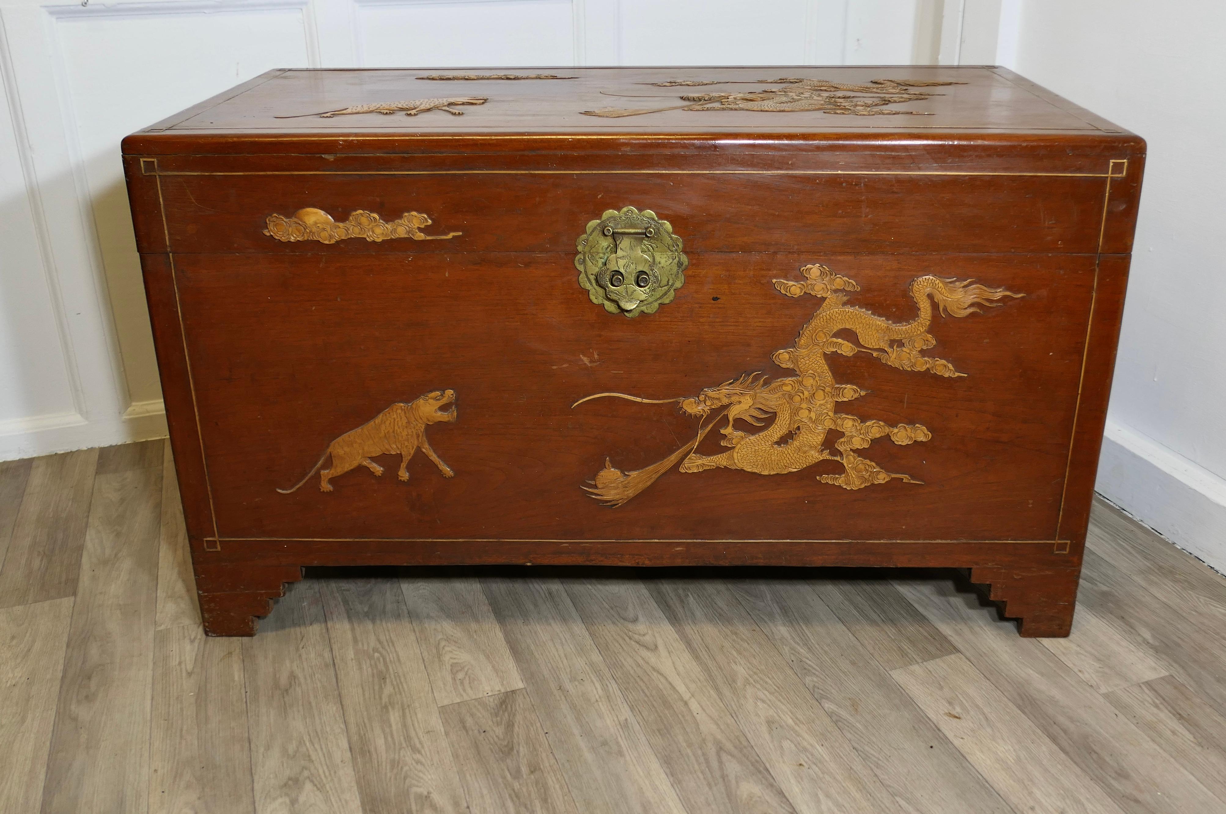 Large Decorated Camphor Wood Blanket Chest

This Beautiful Chest is made from and overlaid with Camphor Wood, the decoration is of ships, tigers and dragons
The chest stands on small bracket feet and it is clean inside with a removable tray
The