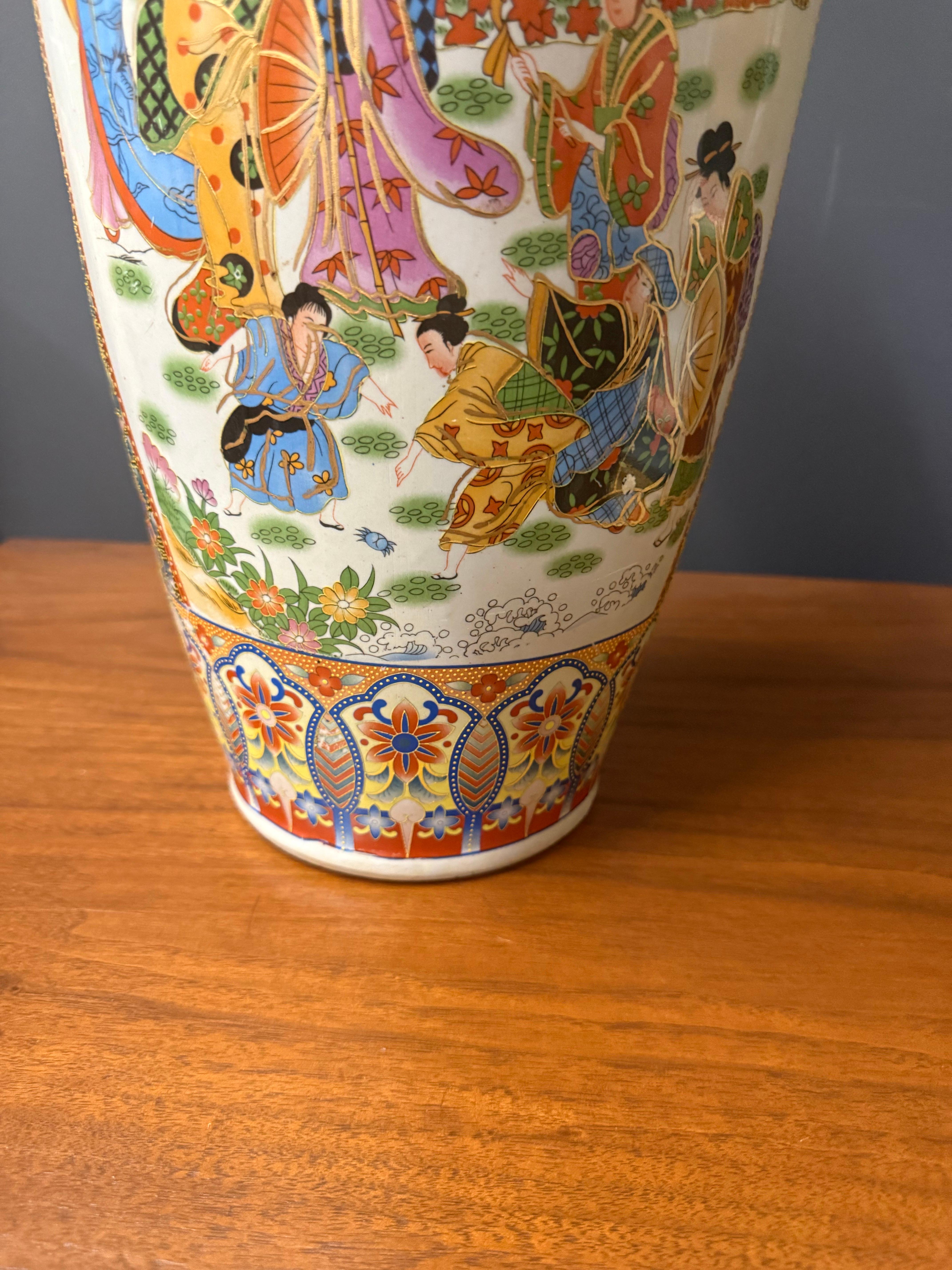 Ceramic vase made in China, finely decorated in Satsuma style. The entire body is hand enameled with intricate garden and family vignettes accented in gold.

Striking Chinese export vase, richly decorated with hand-painted Satsuma style scenes and