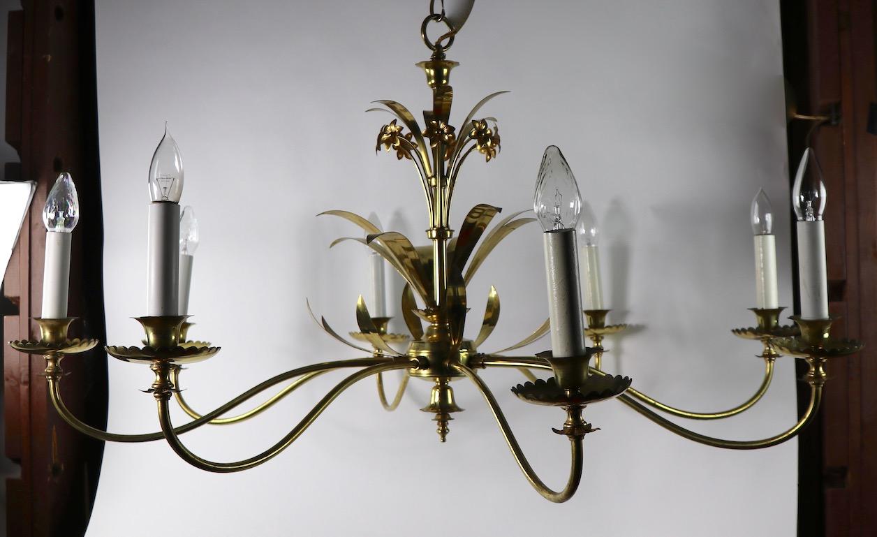 Large and impressive 8-arm chandelier by Halcolite. This decorative fixture features brass leaves and flowers, elegant long and sweeping arms with candle style lights. Original and working condition, some cosmetic wear to finish, normal and