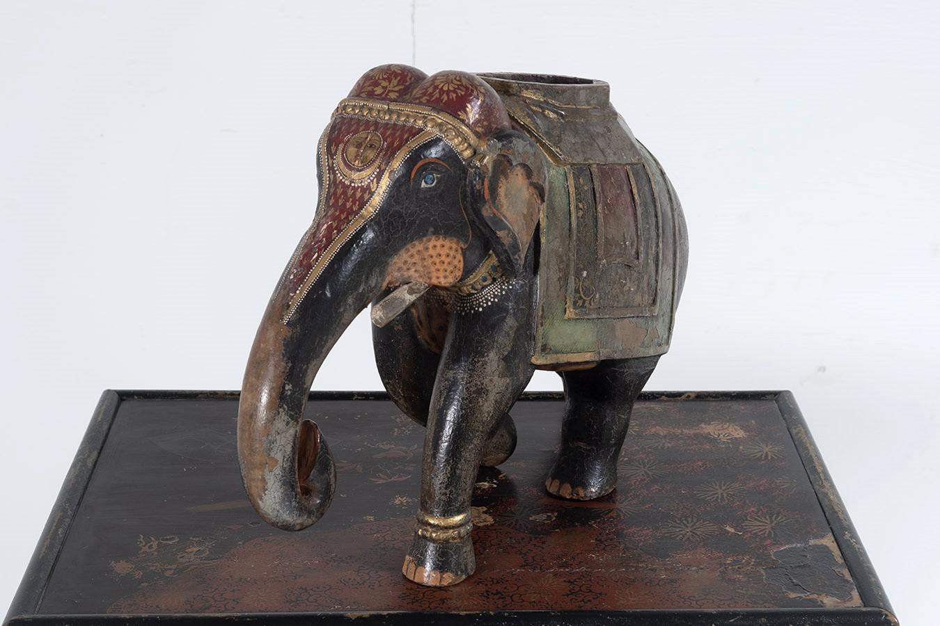 A wonderful example of an Indian Carved Elephant in full regalia, this large example has good colour and form, the colourful decoration is still vibrant but has a wondrous worn patina, especially around the head and truck where it has clearly been